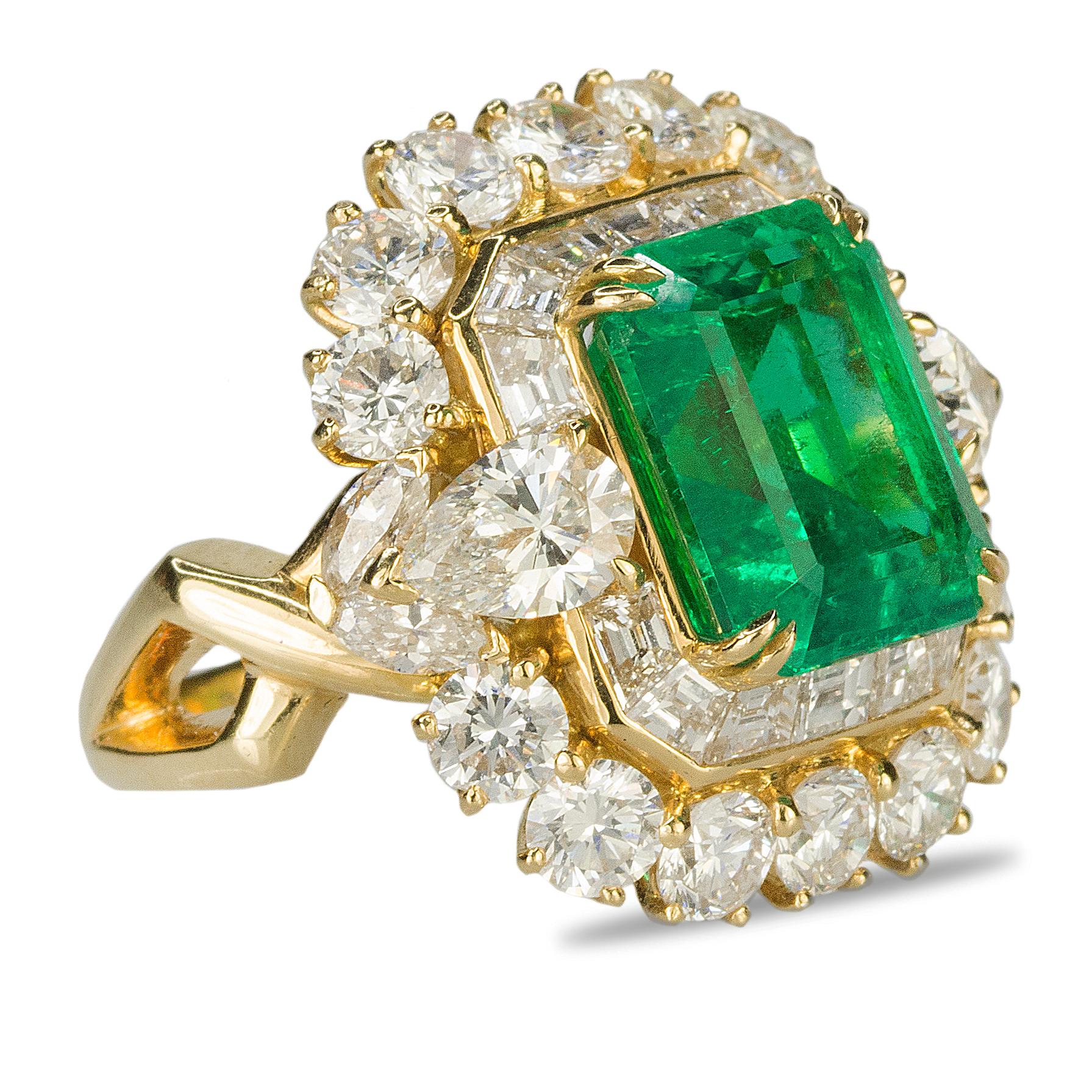 18k ring containing one AGL certified fine 6.25 carat Colombian Emerald and and 2 pear shape diamonds, 14 round brilliants and 14 baguette diamonds with a total weight of approximately 5.60