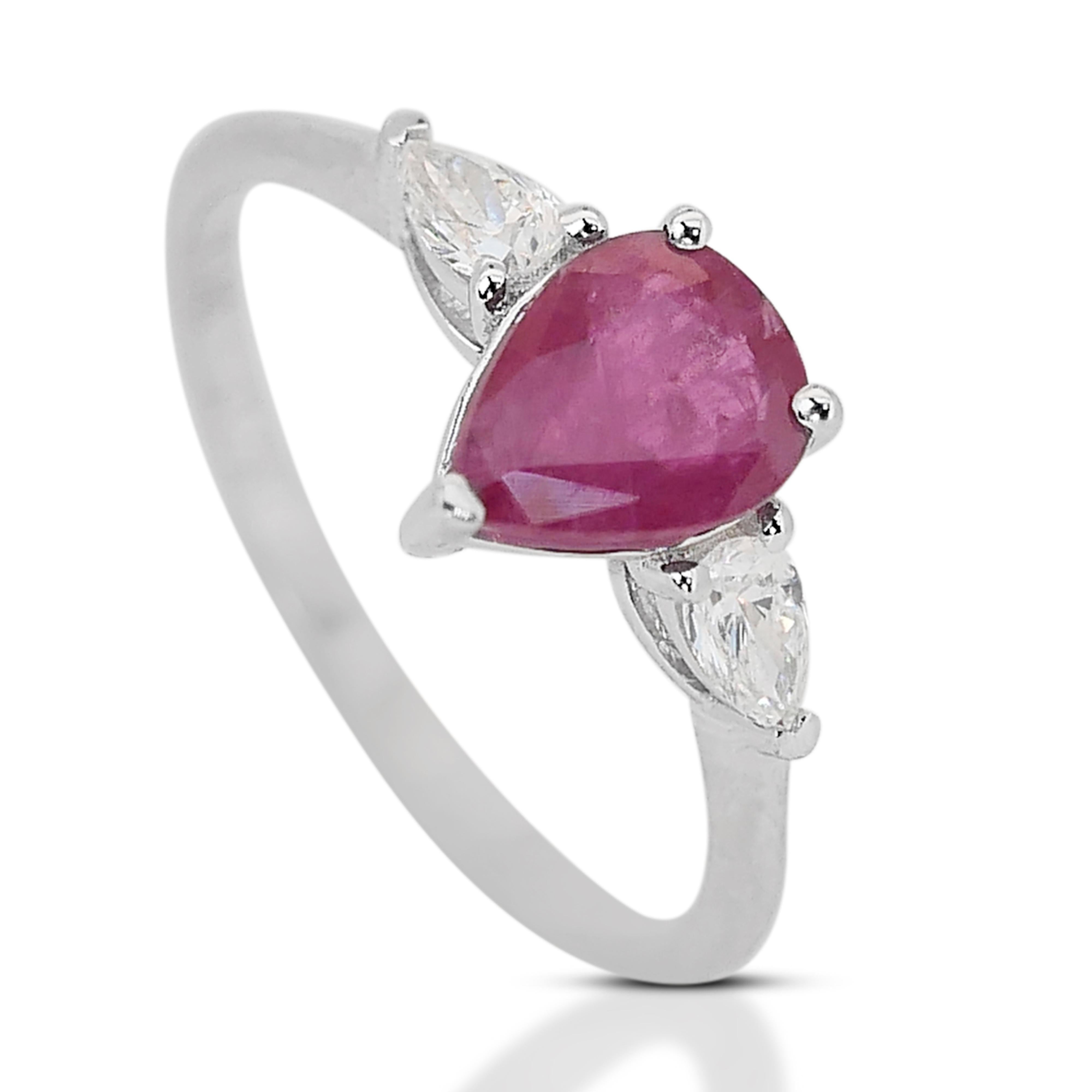 Adorn yourself with this exquisite 3 stone ring, enhancing the allure of the ruby, two pear-cut diamonds grace the sides with a combined weight of 0.30 carats. This precious ring is authenticated through an IGI Certification. 

1 Ruby Main Stone of