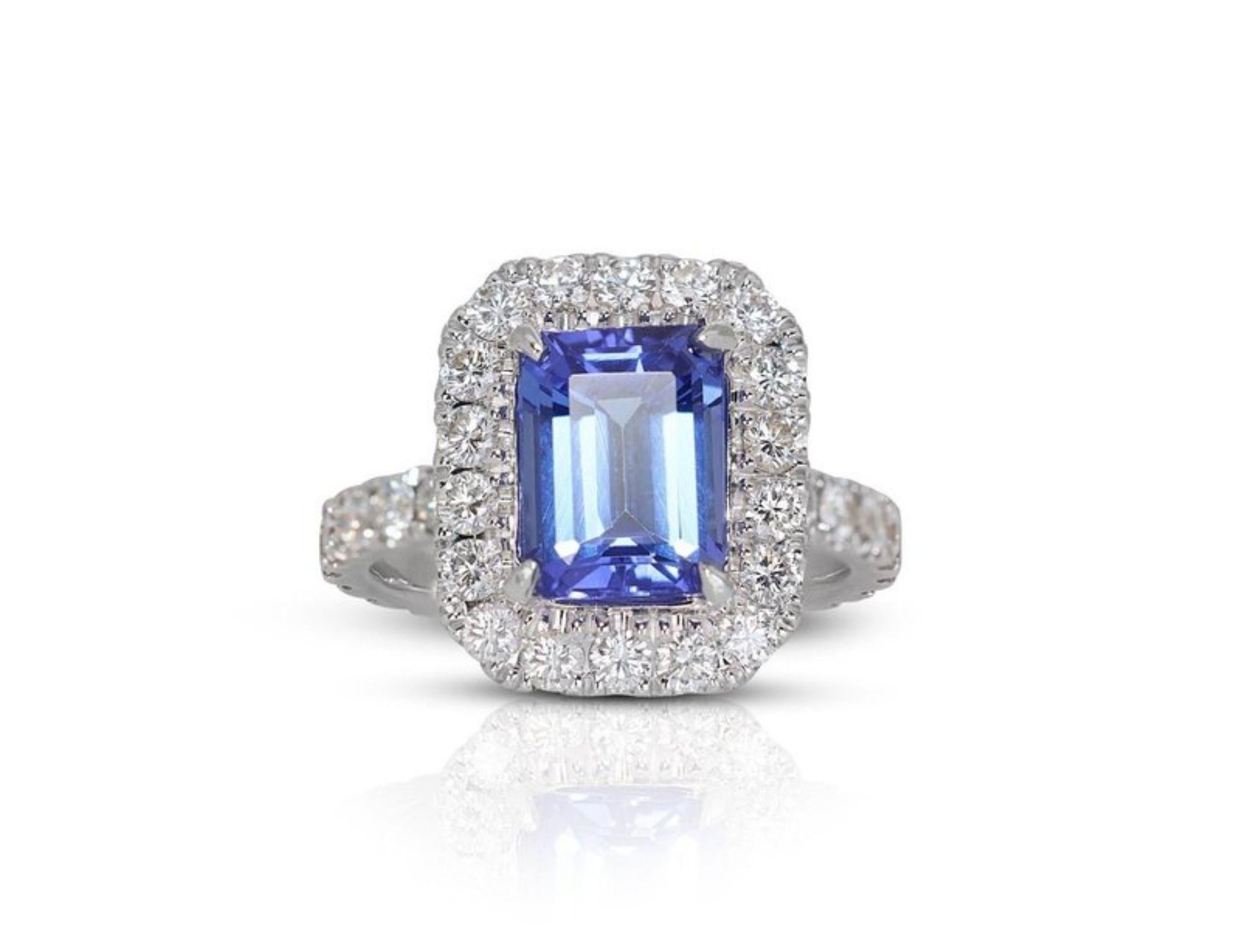 Immerse Yourself in the Ocean's Depths with This Captivating 2.5 Carat Emerald Tanzanite Ring
This ring is a breathtaking vision of the ocean's depths, where a mesmerizing 2.5 carat emerald cut tanzanite reigns supreme. Its captivating violetish