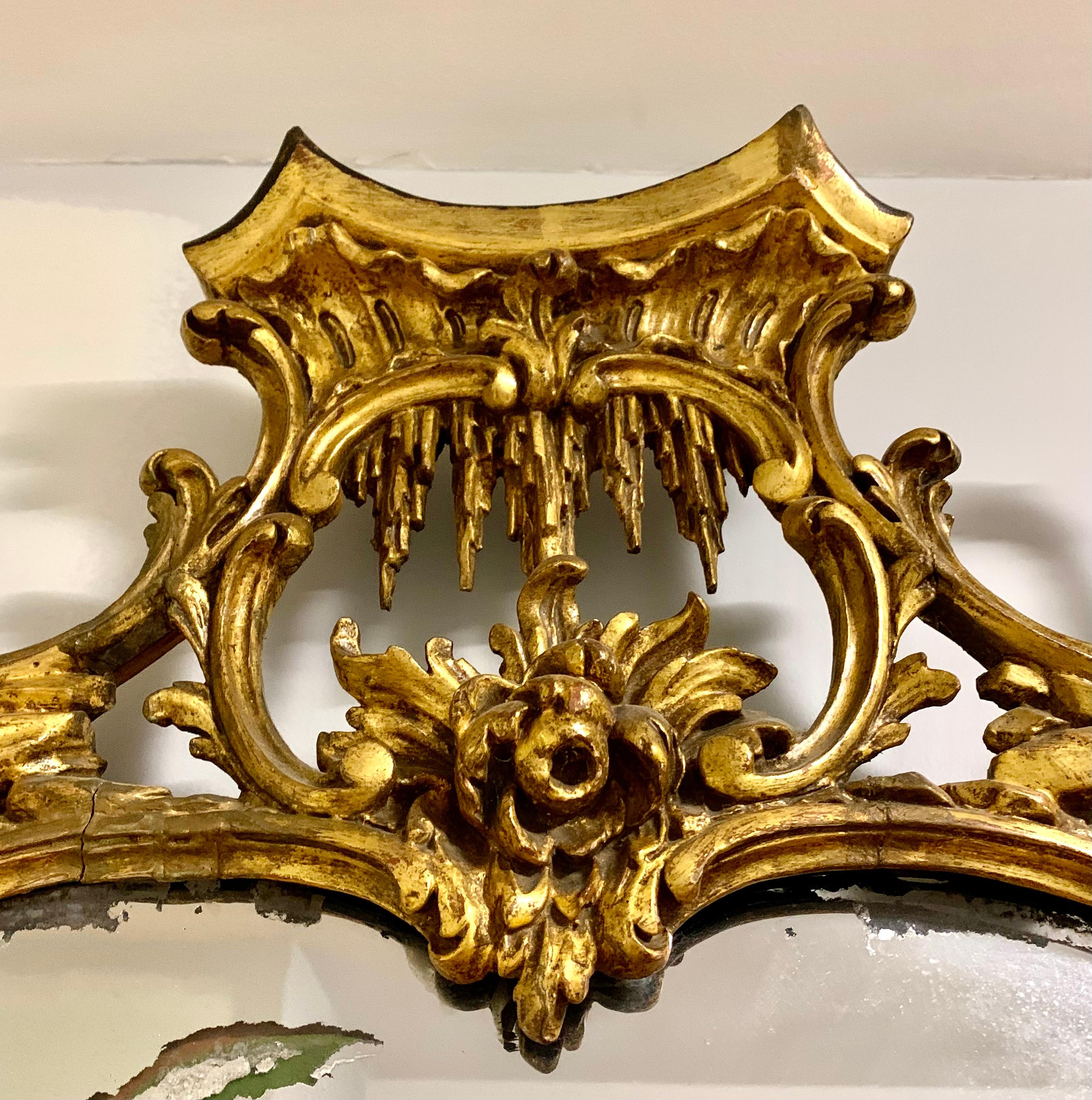 A superb 18th century Chinese Chippendale carved giltwood mirror of exceptional detail.
The pierced foliate frame with climbing roses on architectural column elements of pagoda form, with a central Pagoda crest with stylized icicles above a large