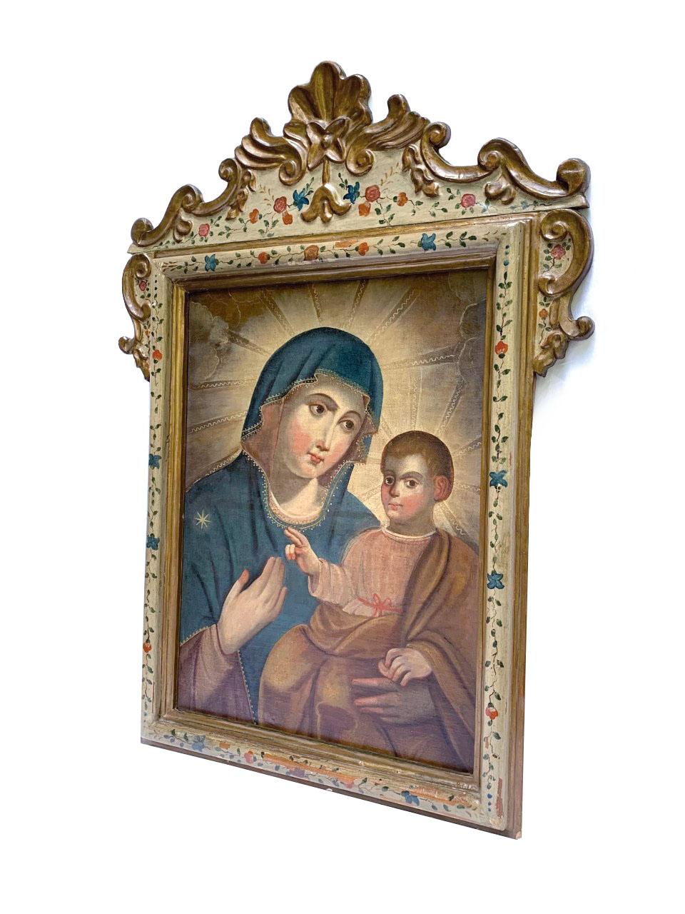Great oil on canvas depicting Madonna and Child. Carved, gilded and polychrome wooden frame with floral arrangements. Venetian, 18th Century.
Dimensions in centimeters: CANVAS 69cm H x 51cm / FRAME 107cm H x 80cm.

In art, a Madonna  is a