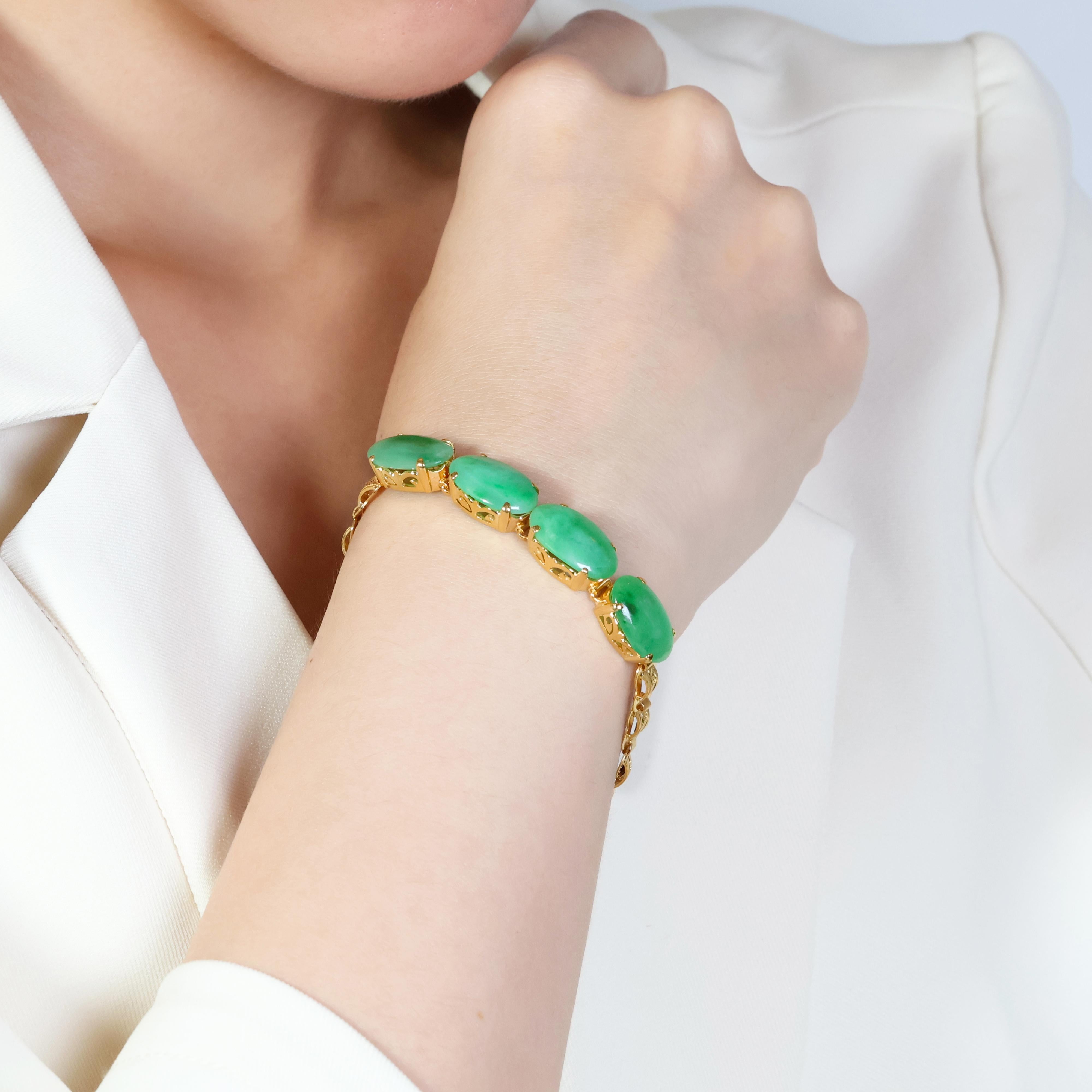 Unveiling a captivating 22K yellow gold bracelet adorned with four stunning jade cabochons. Each jade cabochon is meticulously carved into an elegant oval shape, boasting a captivating green color that will undoubtedly turn heads.  The combined
