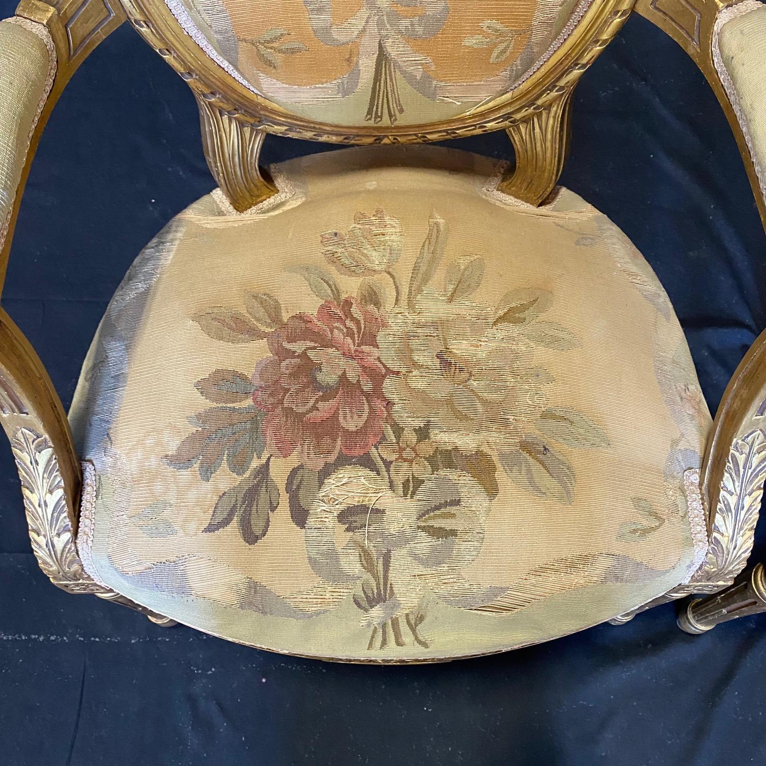 A magnificent pair of French Louis XVI walnut and richly upholstered armchairs in rare handwoven Aubusson tapestries. The quality of the Aubusson tapestries is wonderful but as expected, some minor threadbare areas on the edges of the seats. Arm