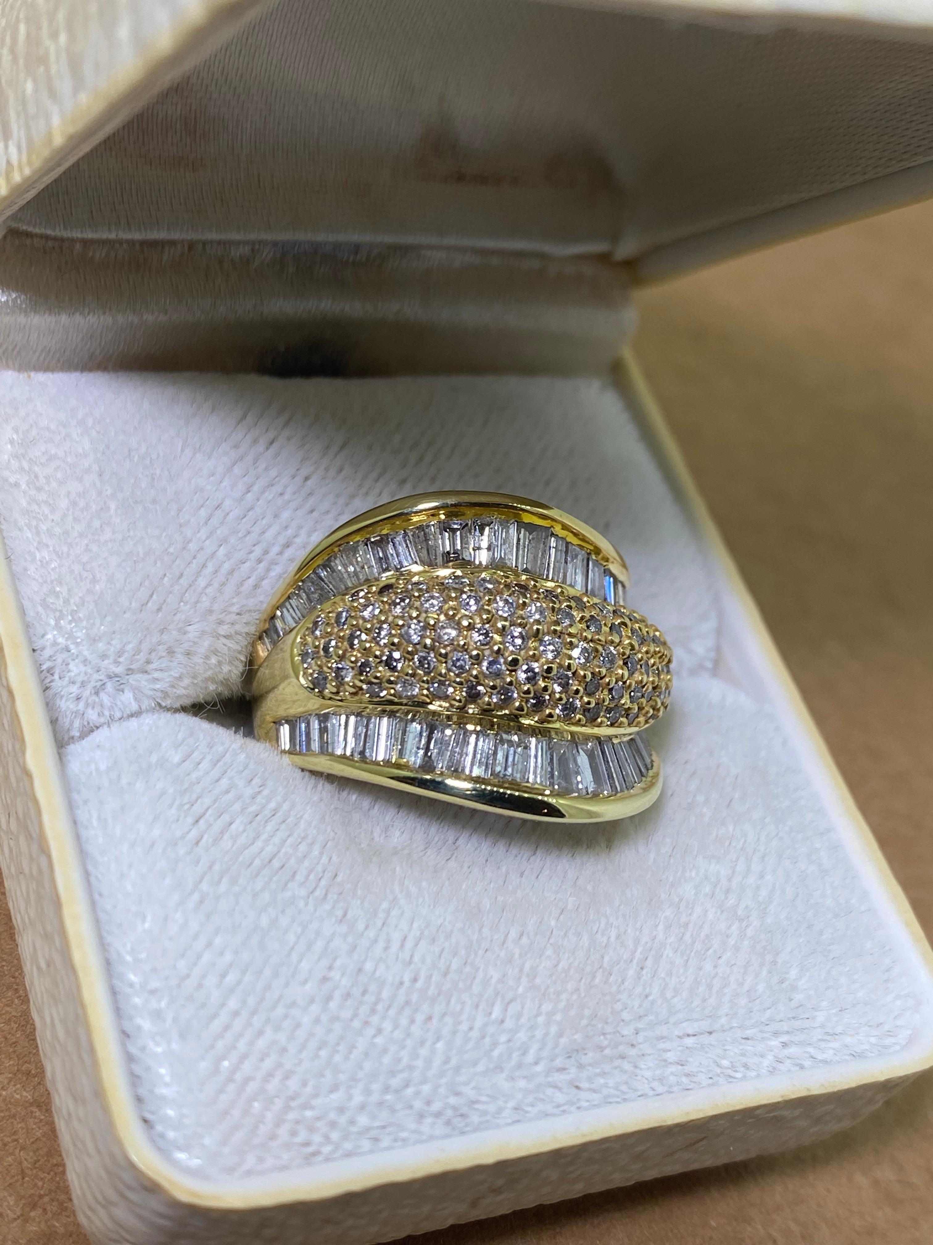 This superb cocktail cluster ring 
is retro, dating back to circa 1960's
yet of timeless design, 
lavishly set with sparkling baguette cut diamonds 
in 2 rows, channel set 

with middle / centre section, 
pave set with round brilliant cut diamonds