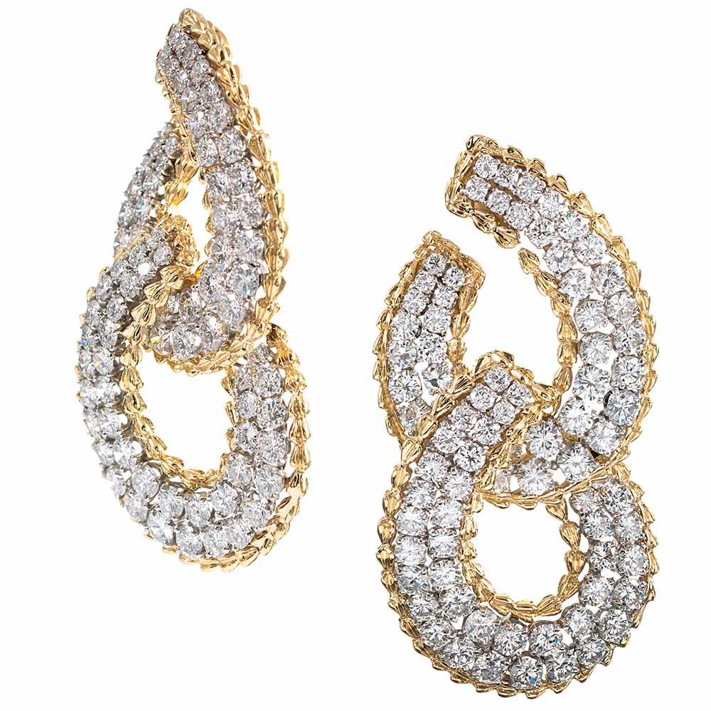 Show-stopping and important, these glamourous ear pendants are made of platinum & 18 karat yellow gold and appointed with an impressive 30 carats of round brilliant diamonds. The double link design is sophisticated and moves gently on the ear,