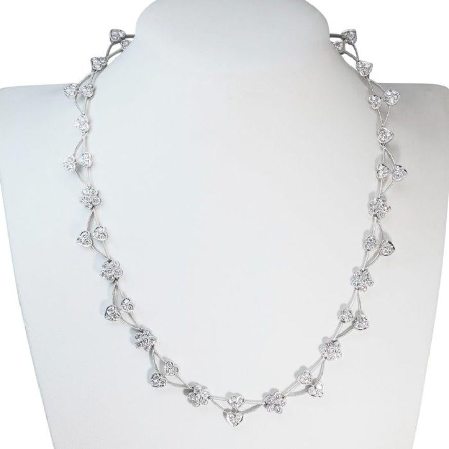 This magnificent necklace features a stunning centerpiece adorned with 150 round brilliant-cut diamonds, totaling 4.20 carats. Each diamond exhibits a near-colorless hue within the F-G range, radiating brilliance and sophistication. With exceptional