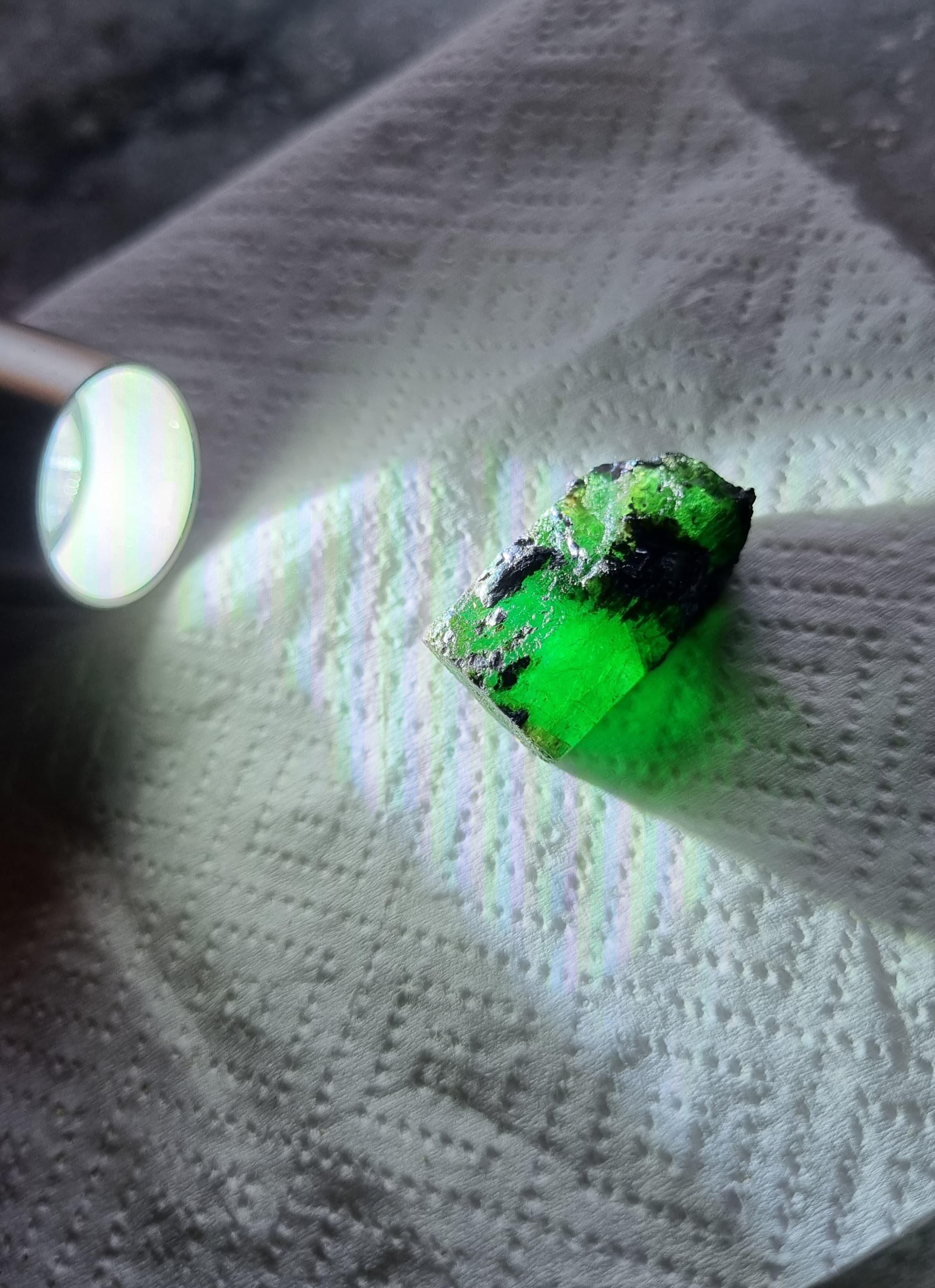 Presenting an extraordinary 44.75-carat Brazilian rough emerald, radiating a captivating glow and an intense, vibrant green hue. Extracted from Brazil's renowned emerald mines, this impressive gemstone displays a remarkable natural translucency,