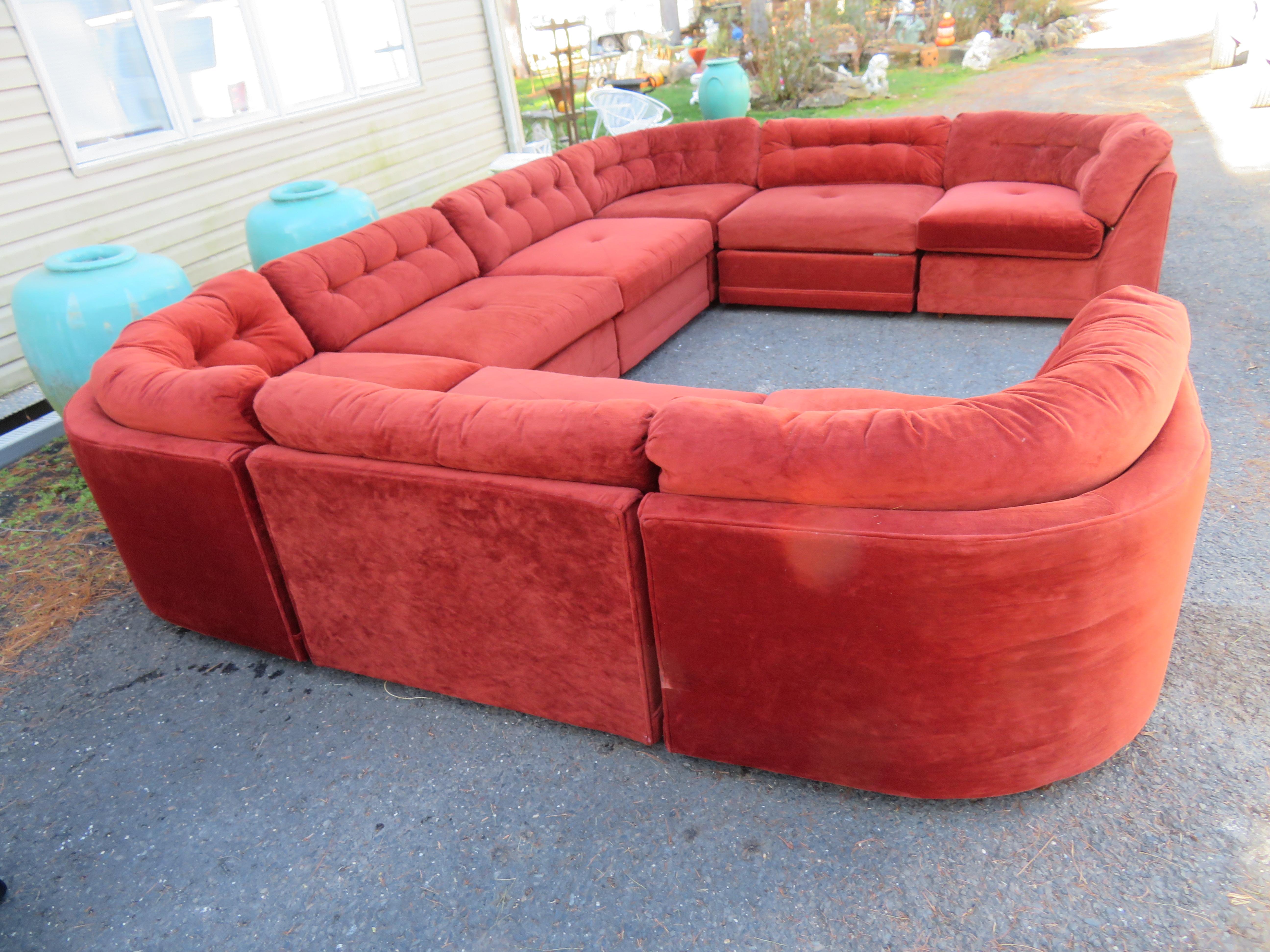 Magnificent Milo Baughman style 8 piece curved orange velveteen sectional sofa. Four corner pieces and four center pieces. This is one of those rare vintage sofa sectionals in very nice original condition and can be used as is. The cushions are