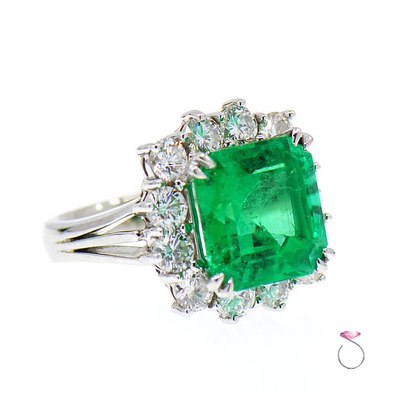 Gorgeous Natural Colombian Emerald & Diamond Halo ring is just stunning. This ring features an approximately 8.50 carat natural square Emerald  cut in the center surrounded by a beautiful diamond halo. The 8.50 carat center Colombian Green Emerald
