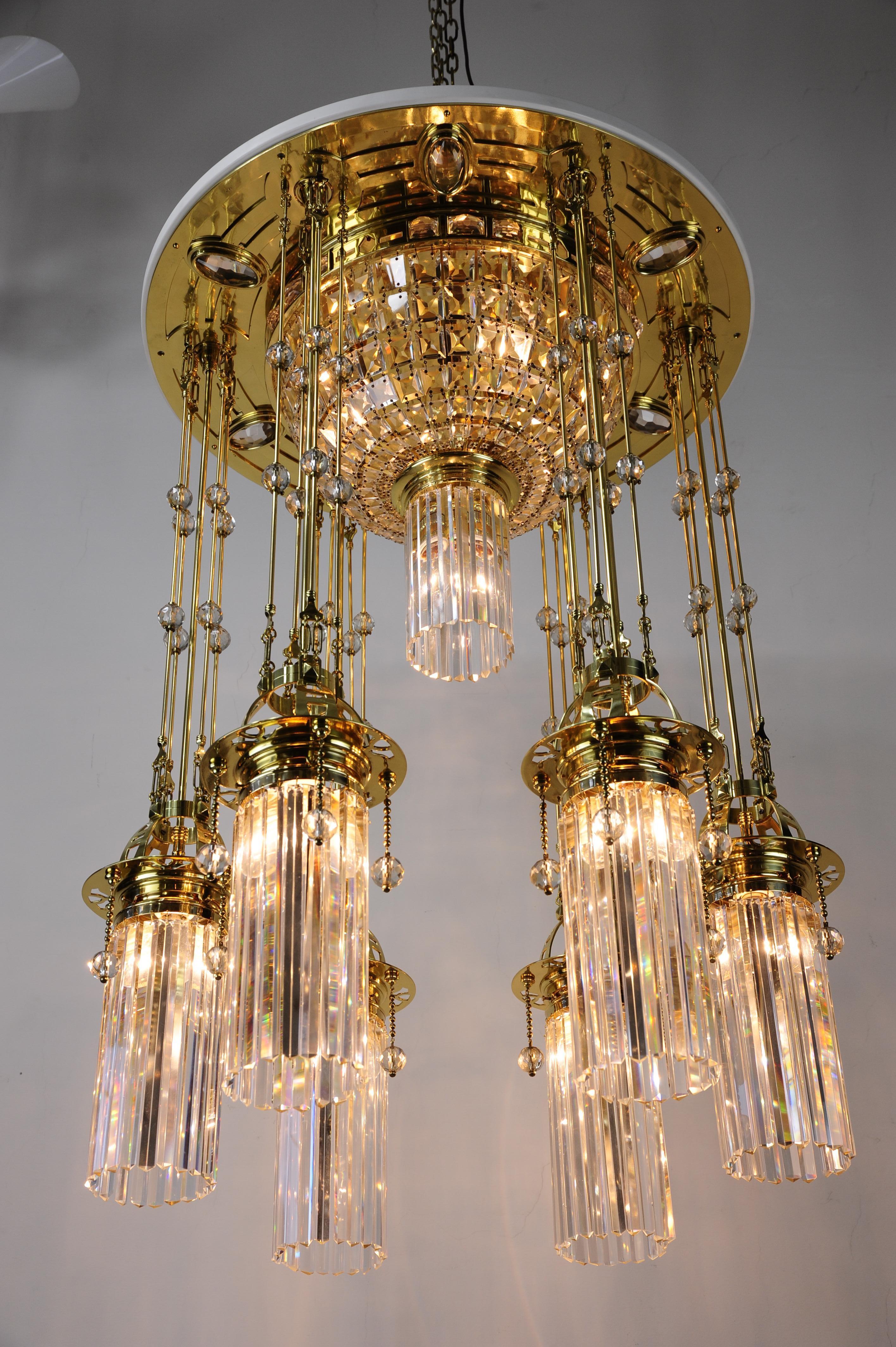 Magnificent and huge Art Deco chandelier Vienna of the 1920s.
Polished brass and stove enameled.
The crystal parts of the chandelier are original.
The chandelier was expertly restored and the crystal was carefully cleaned by hand.
The chandelier