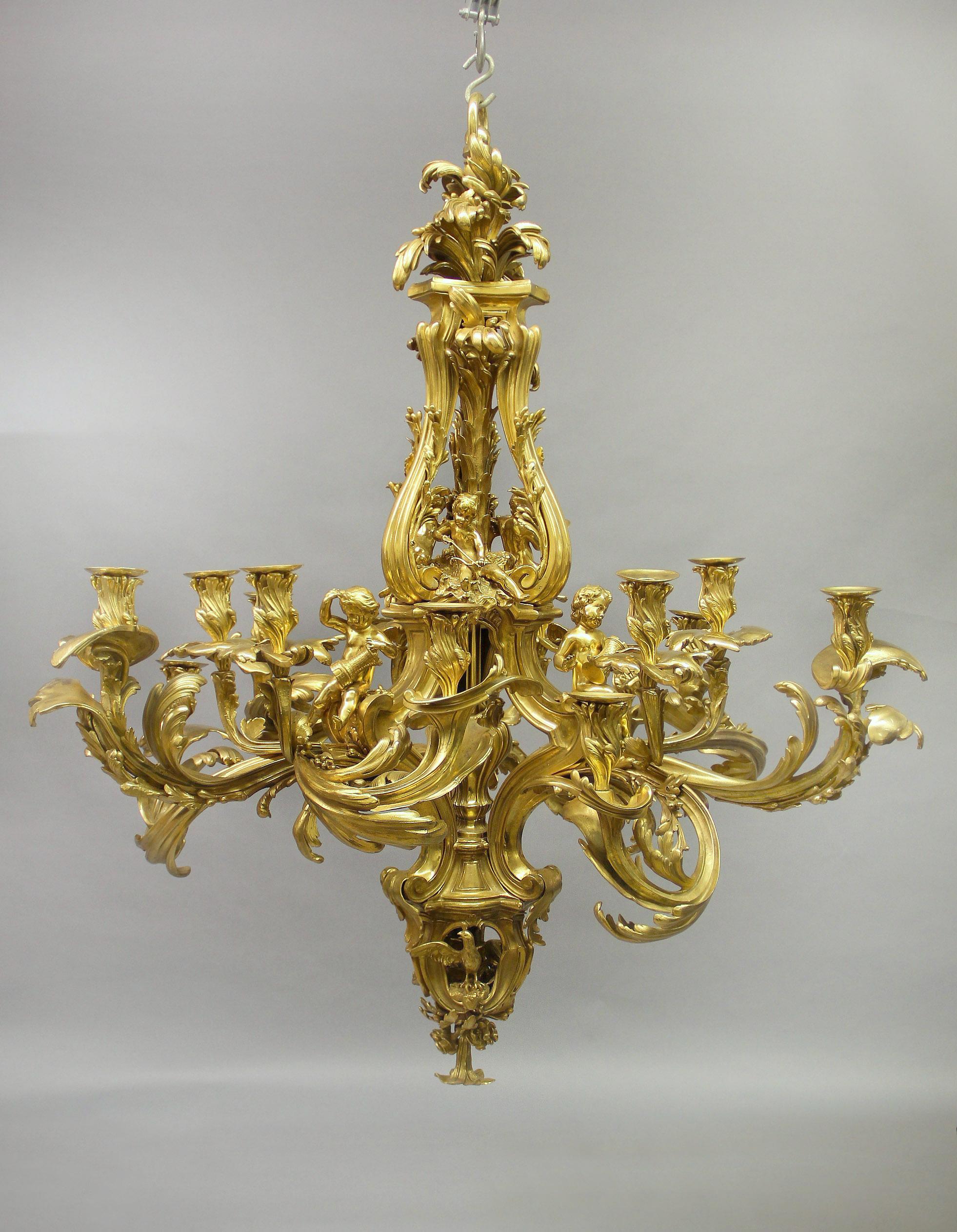 A Magnificent and Palatial late 19th/early 20th century gilt bronze fifteen light chandelier

After the Famous 18th Century Model by Jacques Caffiéri

This wonderful chandelier is centered by a baluster shaped open central stem, surmounted by