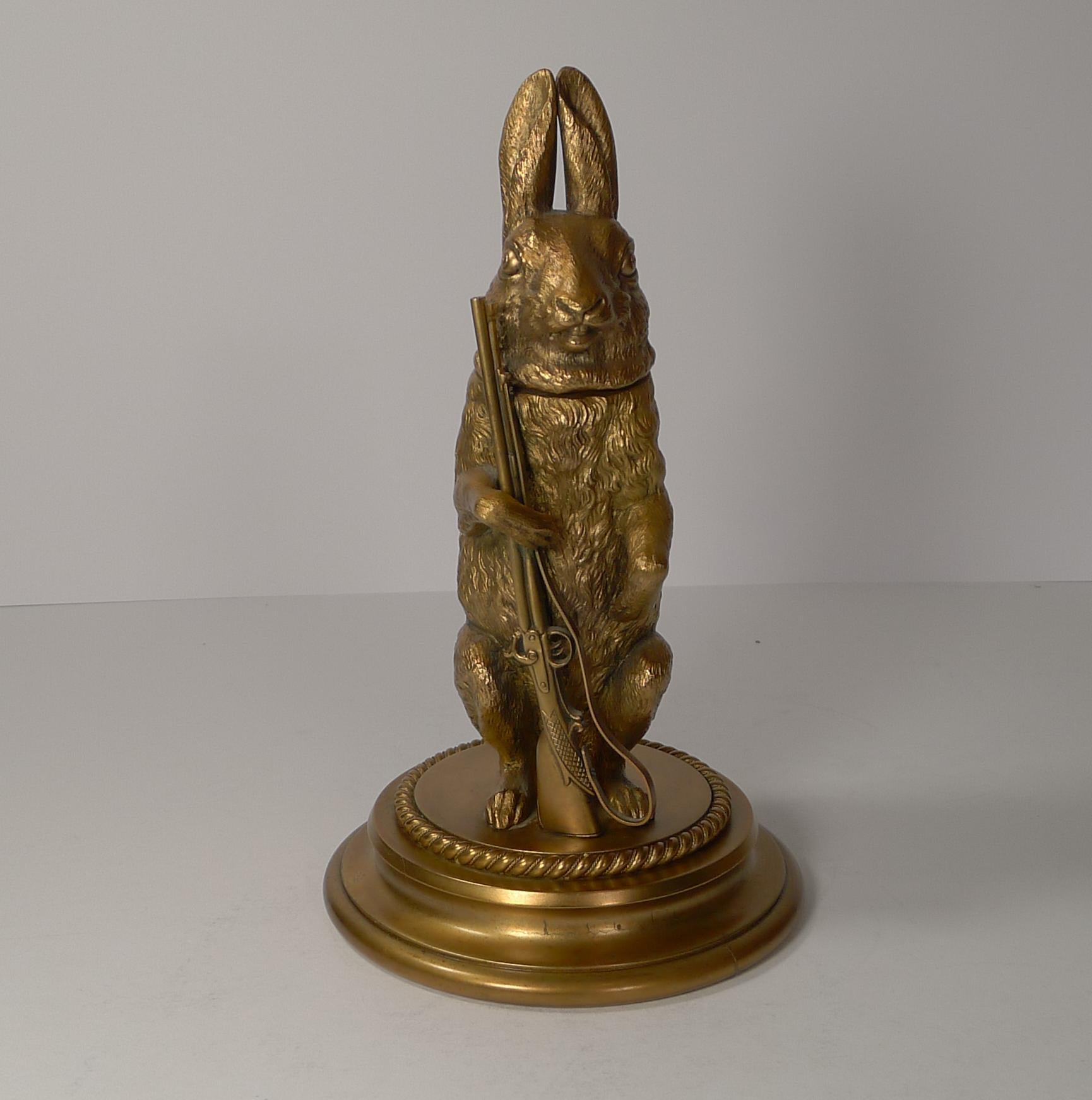 A truly fabulous Victorian novelty inkwell made from solid cast bronze in the form of a hunting Hare holding a rifle, smothered in the original gold with a fabulous antique patina.

The hinged lid opens to reveal the ink chamber within,

Dating