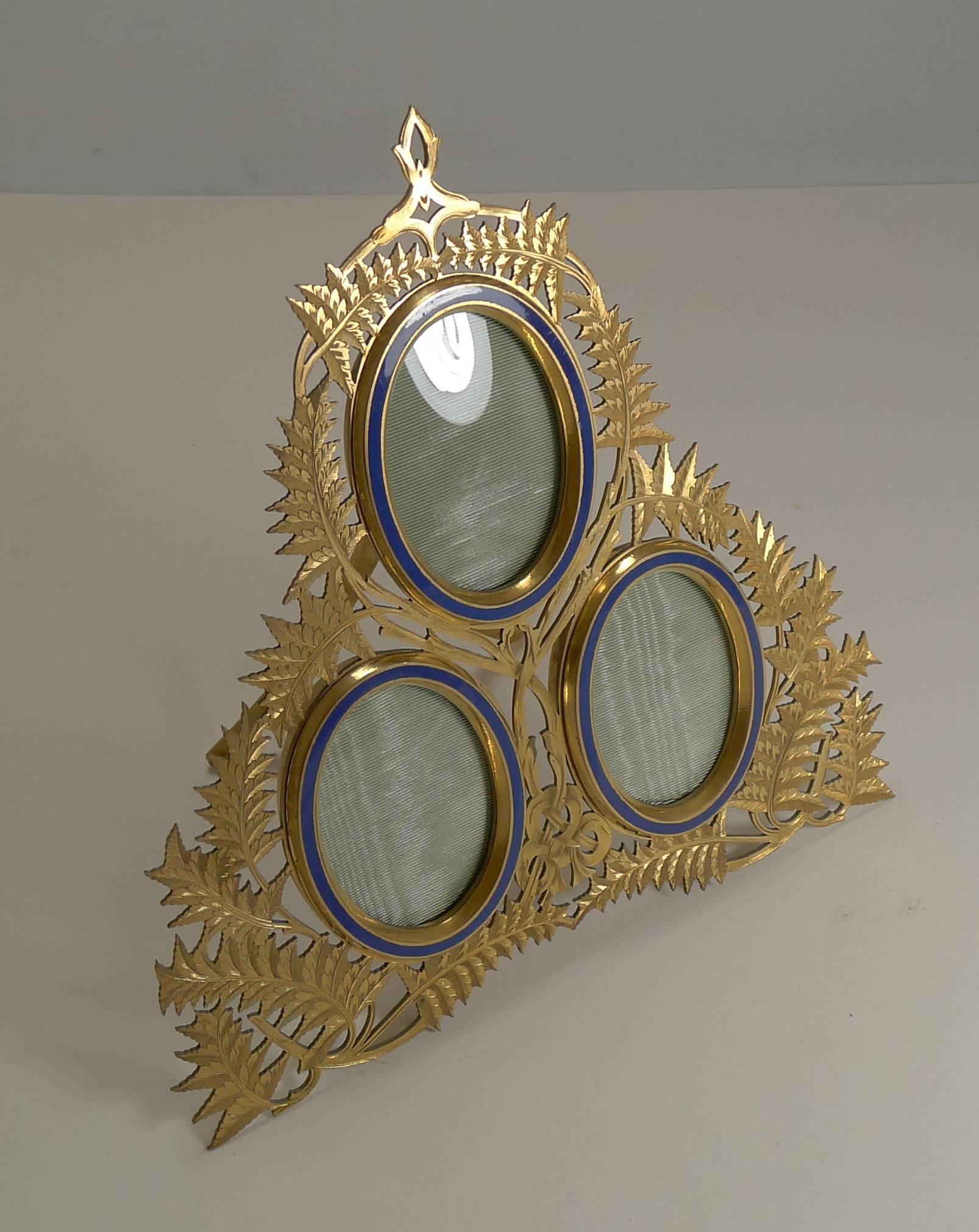 A beautiful quality triple photograph frame, cast with a myriad of Fern motifs, very English and very Victorian, and today, highly sought-after.

Cast in bronze, the frame retains the original gilded (gold) finish, in excellent condition. The