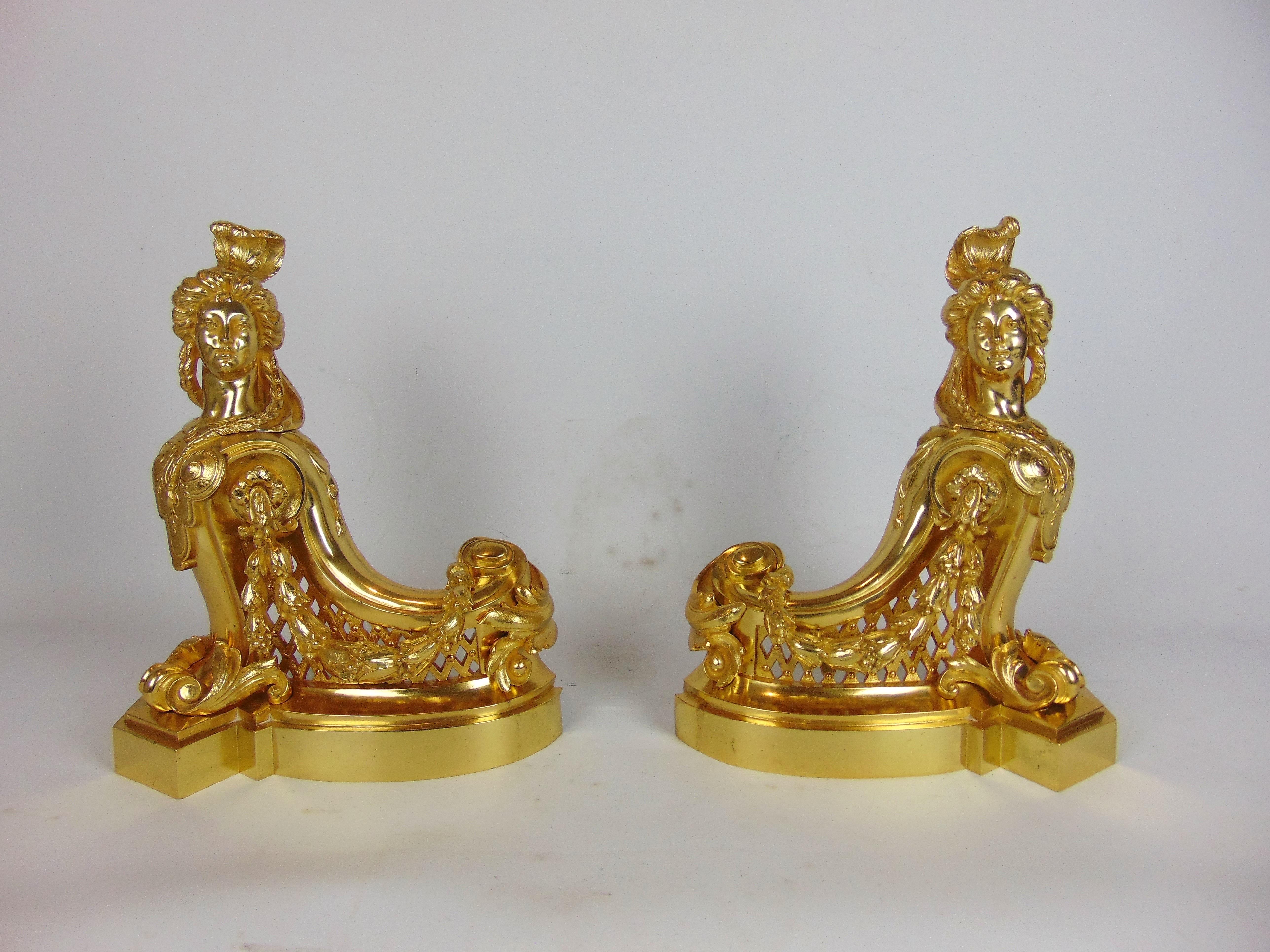 A superb Gilt Bronze Fender high quality casting in the form of twin classical female figures each with feathers to their heads as their platted hair is draped across dressed torso which sweeps down to a central pieced fret work central bar , can be