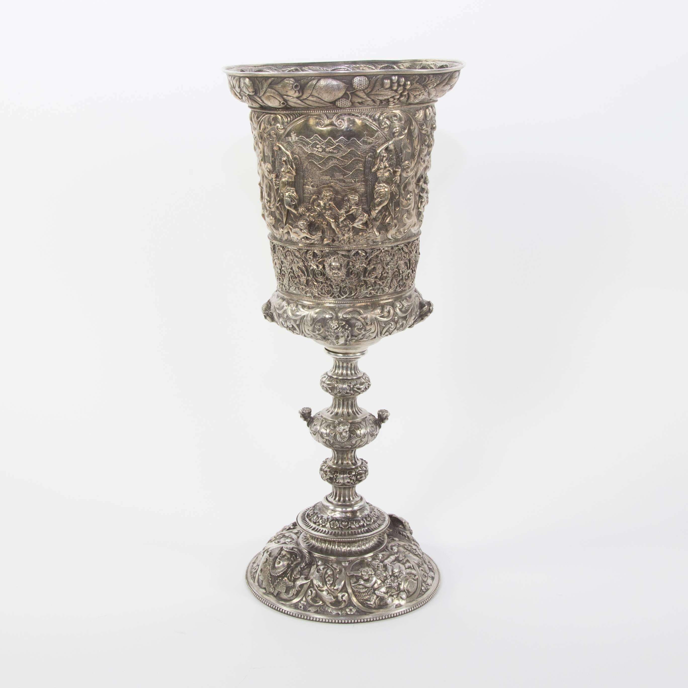 Sensational large silver tiered chalice beautifully handcrafted entirely in silver (800 Silver standard); decorated with motifs in relief, engraved and chased. It is inspired directly in similar pieces influenced by Medieval Germany, in full