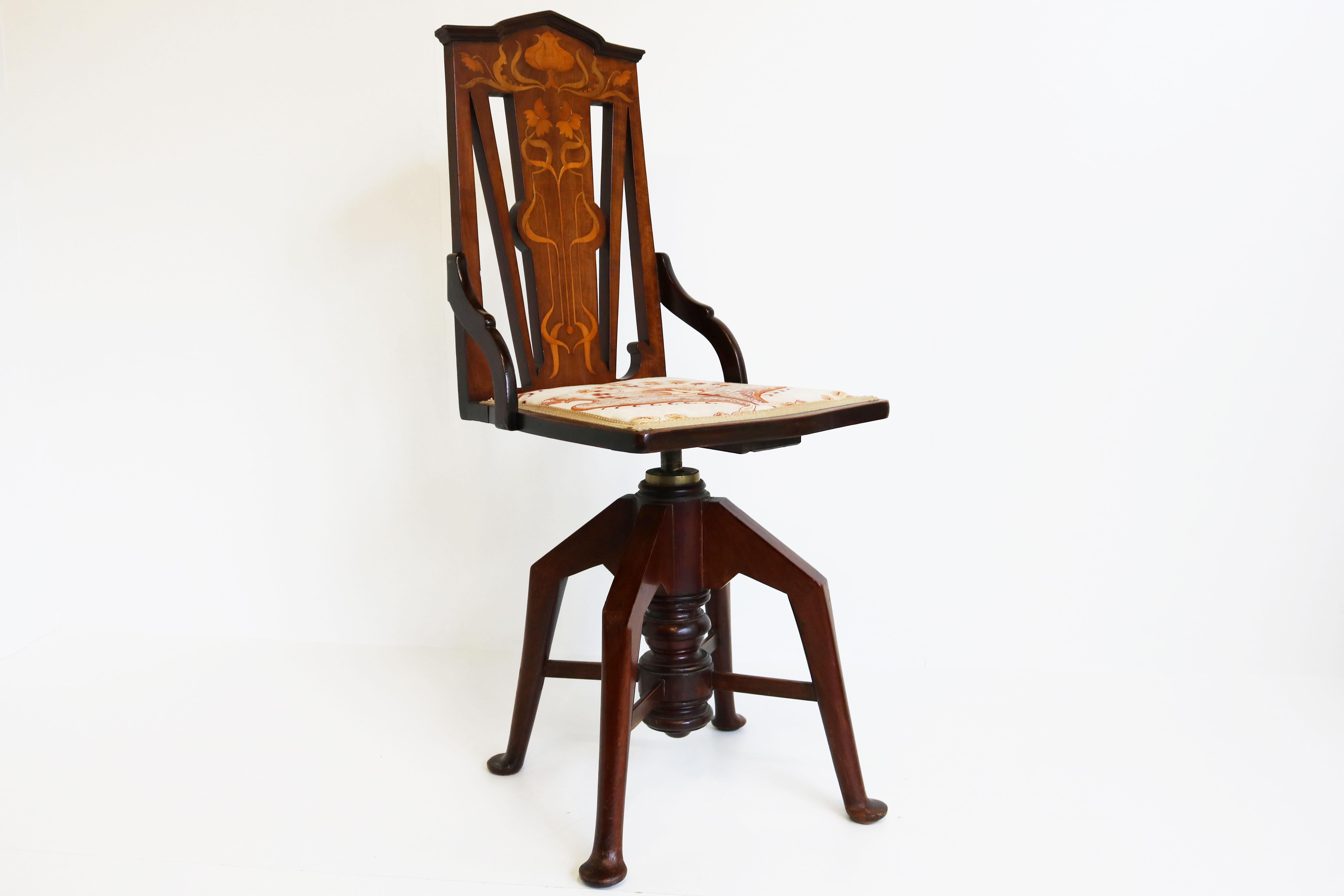 Wonderful antique Art Nouveau adjustable swivel music chair, circa 1900s in solid mahogany. The chairs back inlaid with classical Art Nouveau flowers and foliage in satinwood, boxwood and various stained woods by hand. High quality piece of