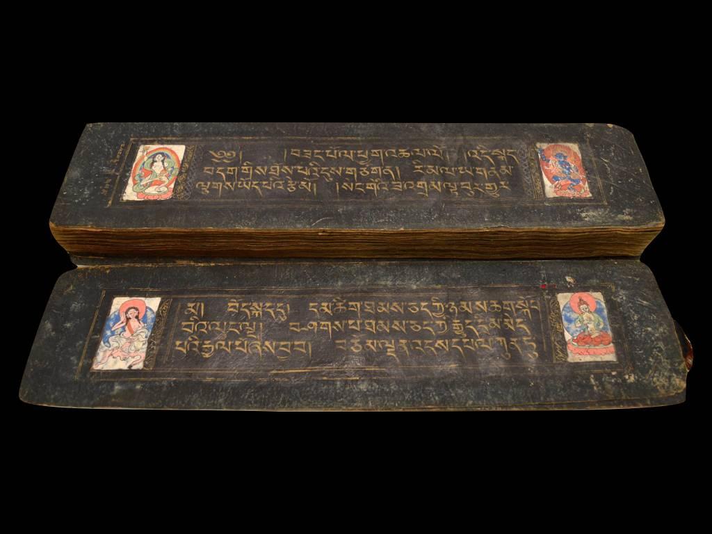 Antique Tibetan prayer book manuscript, possibly 18th century or earlier. This manuscript is made with multi-layered paper, and contains detailed drawings of deities in the first two pages. The writing is in Tibetan headed (dbu can) script using