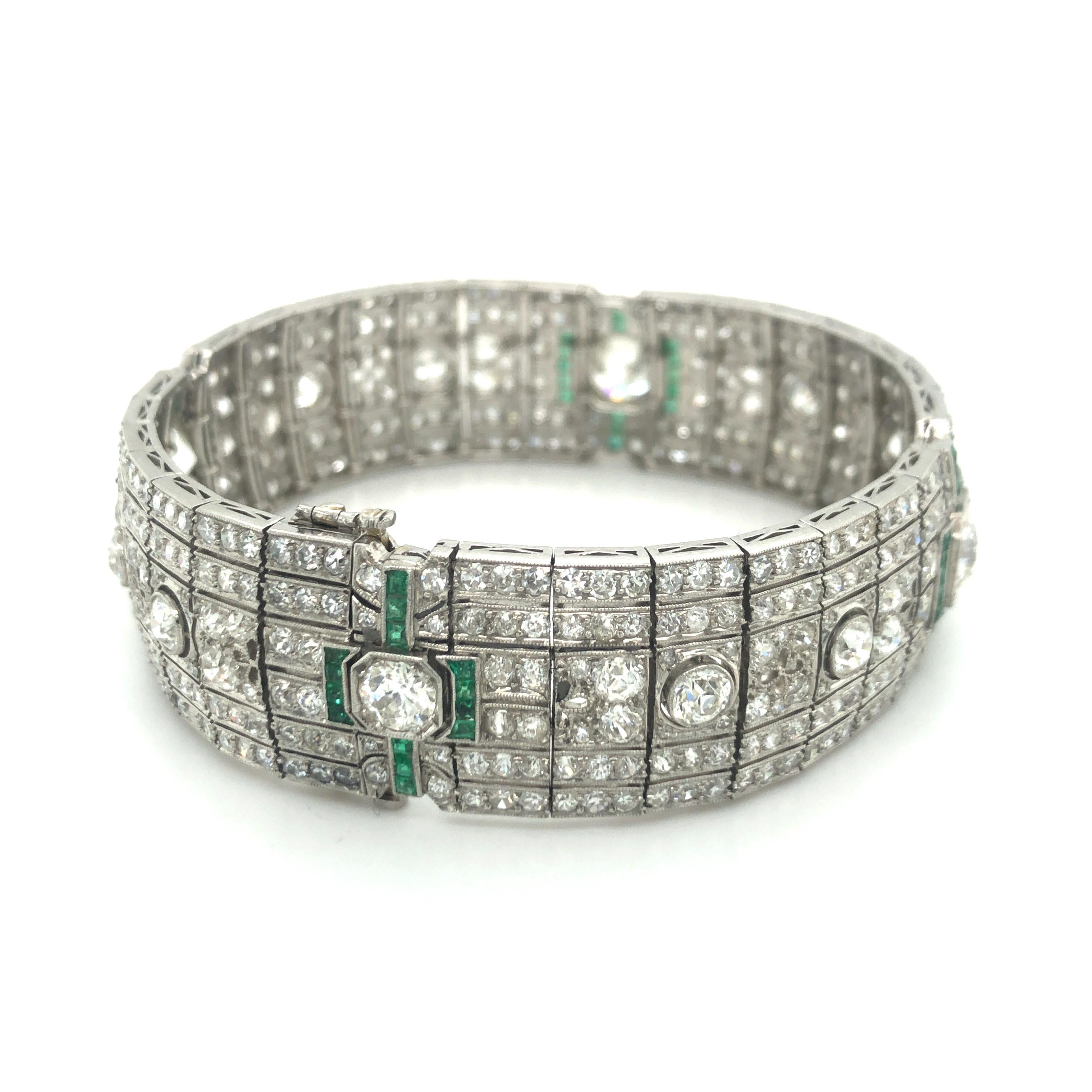 This magnificent bracelet is an exceptionally fine example of its era. Handcrafted in platinum and artfully à-jour-set with 492 old-cut diamonds and 62 square-cut emeralds, this bracelet is a true work of art. 

This bracelet nestles gently around