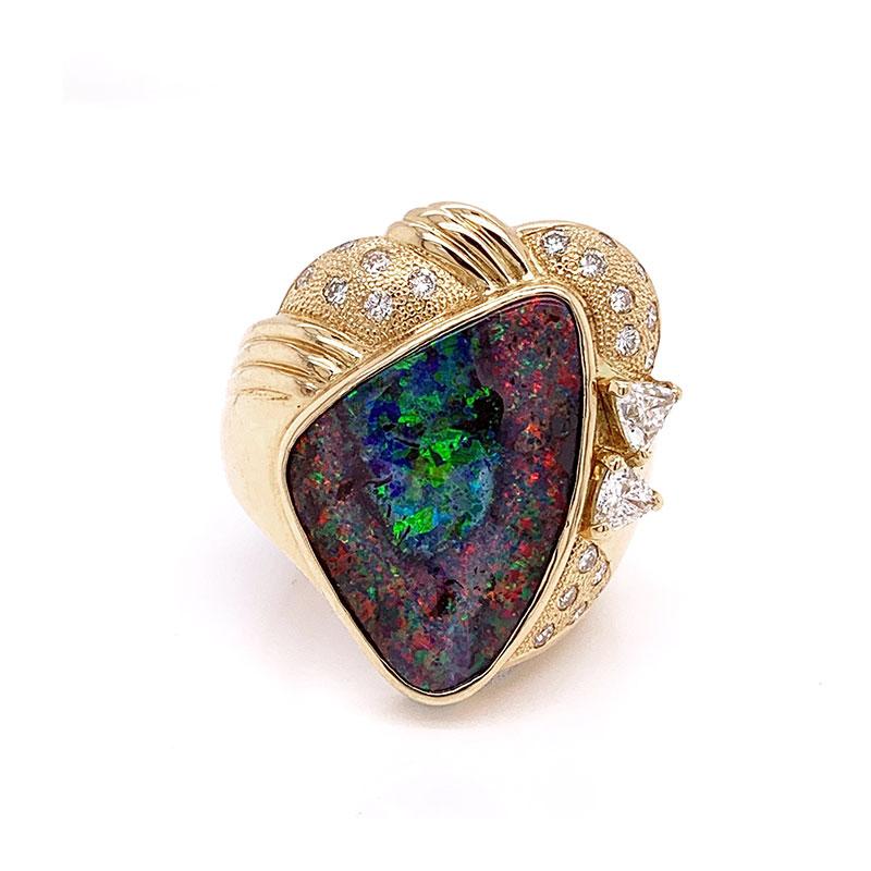 From the fields of Australia this precious boulder opal has the most amazing play of color. It shows strong and bright flashes of red green and blue across the entire stone leaving you mesmerized. It is accented by 0.89 carats of round and