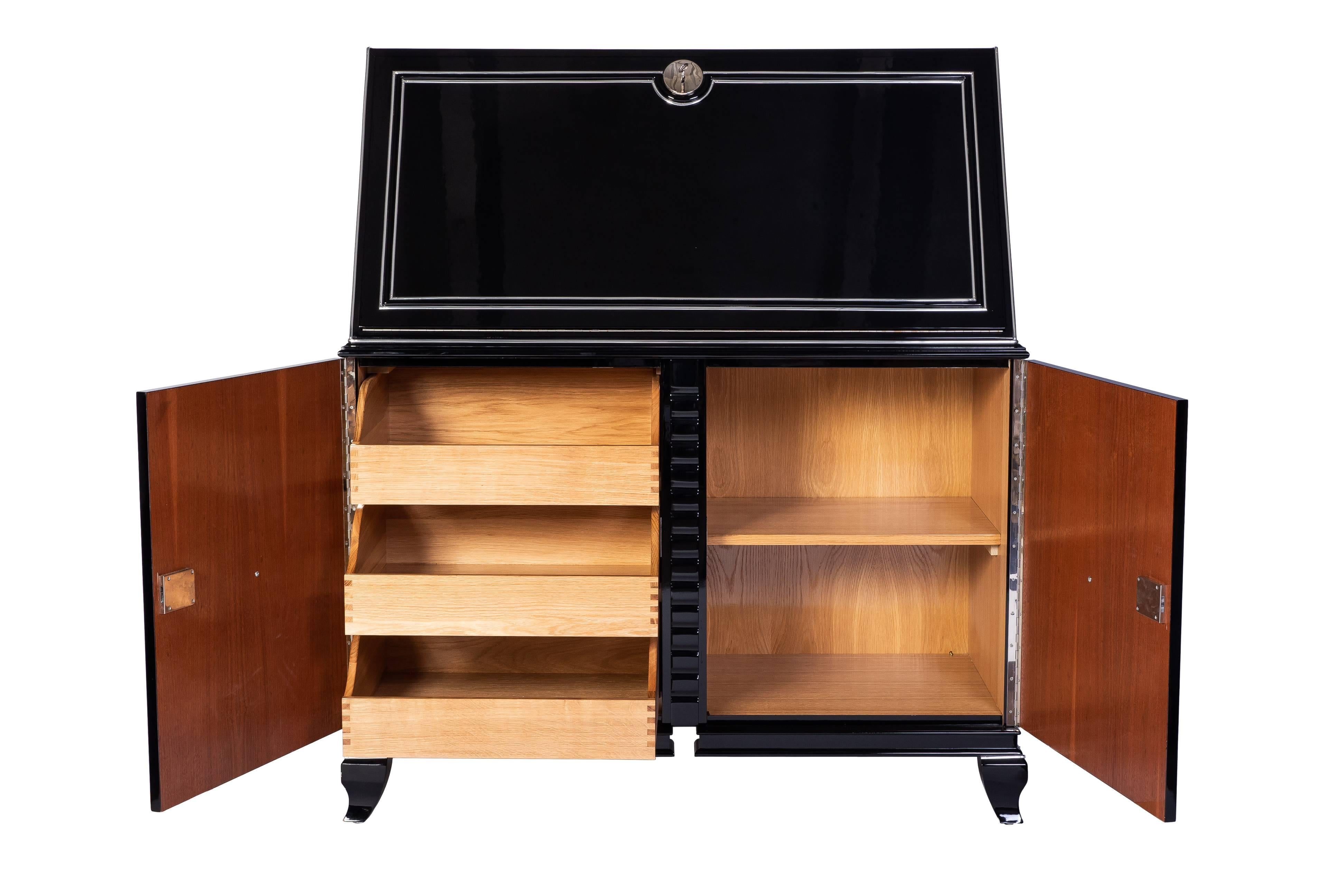 This magnificent Austrian Art Deco secretaire features a beautiful high gloss black lacquer finish with chrome lines and fixtures.
  