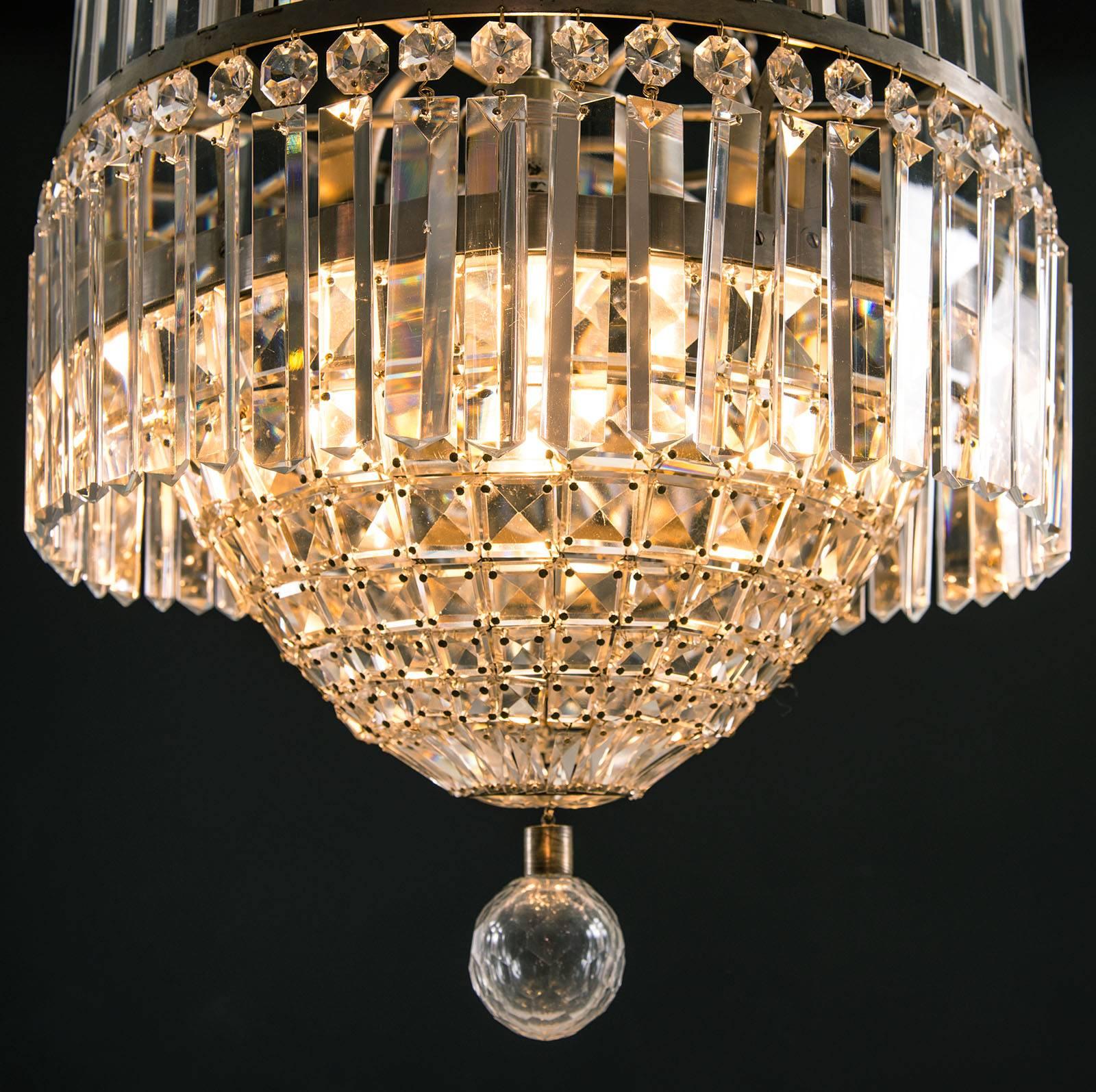 Beautiful parlour chandelier, Mid-Century Modern. Perfect cut.
Material.

Brass, nickel-plated with a patina, hand-cut glass-stones.