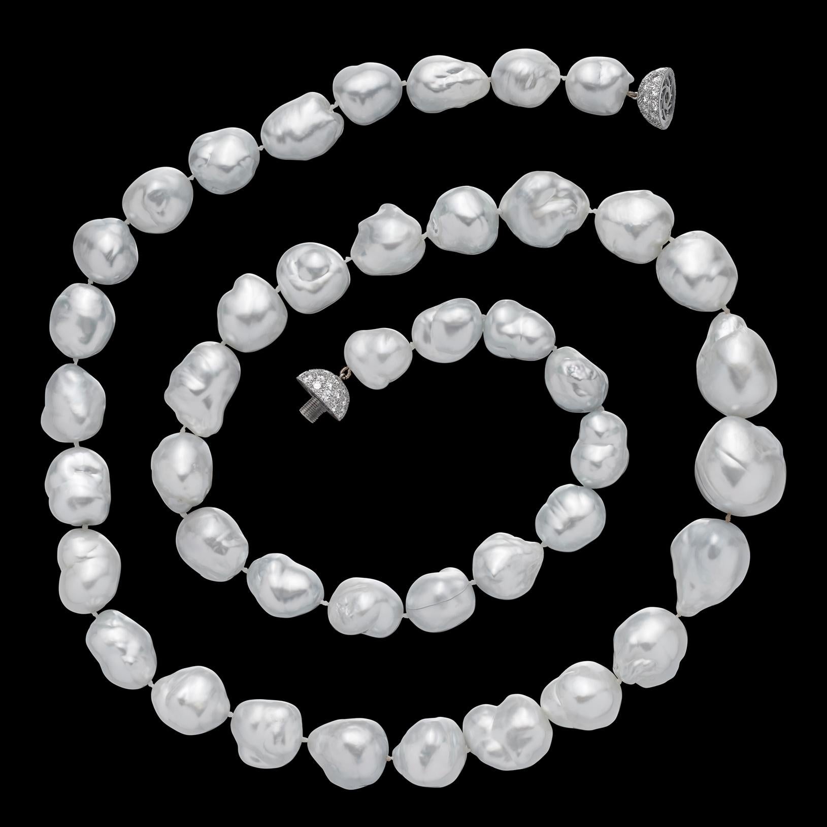 Created by the highly respected House of Assael Pearls and retailed by Neiman Marcus, this glorious strand is composed of high luster, silver white baroque pearl, measuring from 23.70 to 15.0mm, and completed by a platinum and 18k white gold ball
