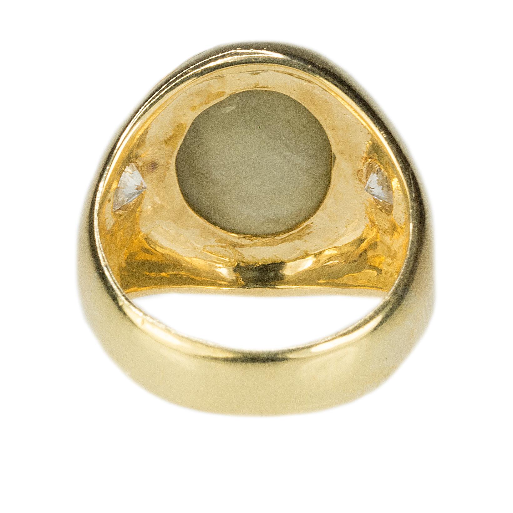 Black Starr & Frost 18k Ring with a gem quality approximate 15.00 carat Cats Eye Chrysoberyl and 2 E-F color VS clarity round brilliant diamonds weighing approximately 0.70 carats. 12.72g