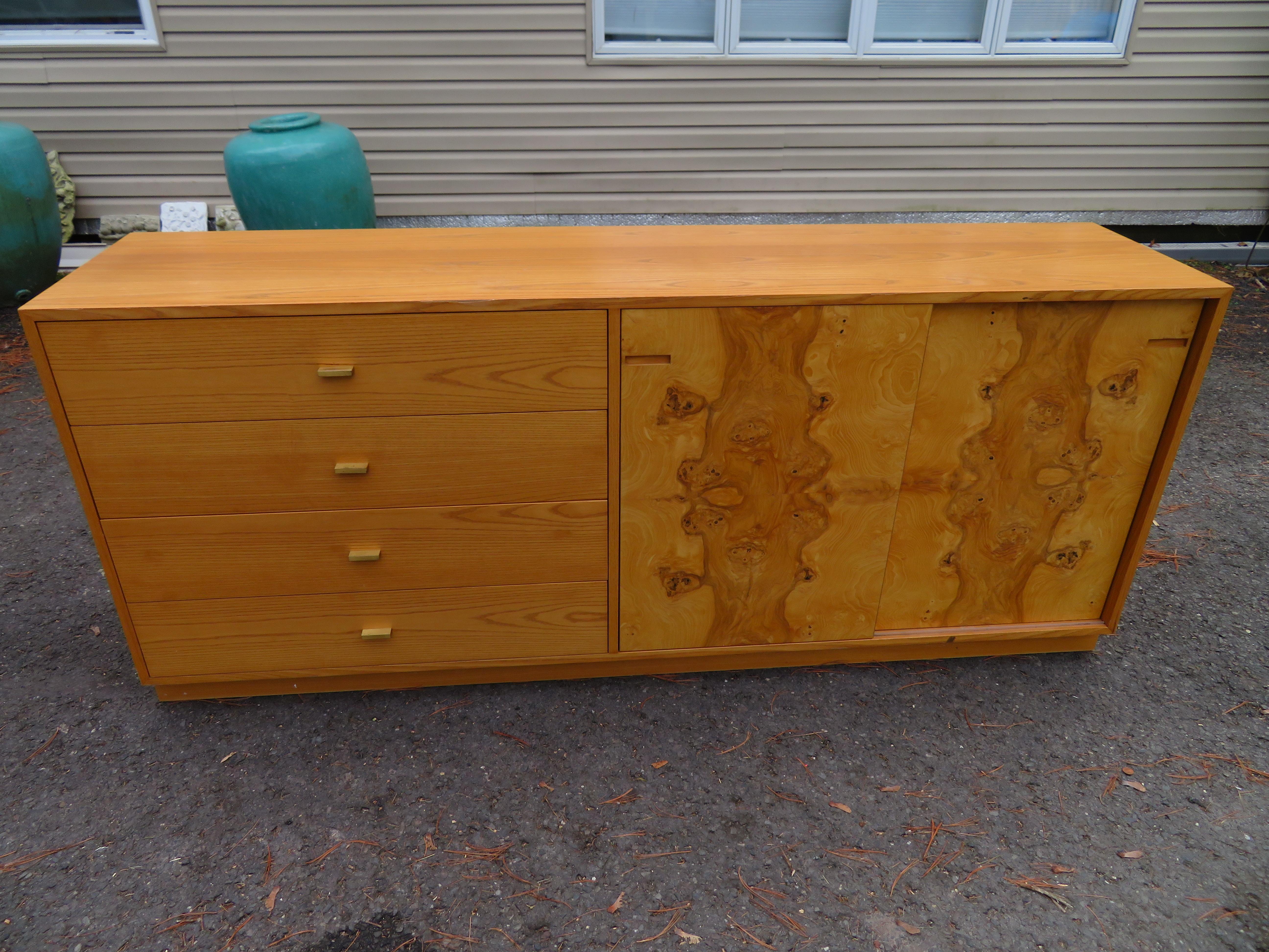 Fantastic burl wood credenza by Harvey Probber. This cabinet has four drawers and two burled front sliding doors revealing two adjustable shelves.