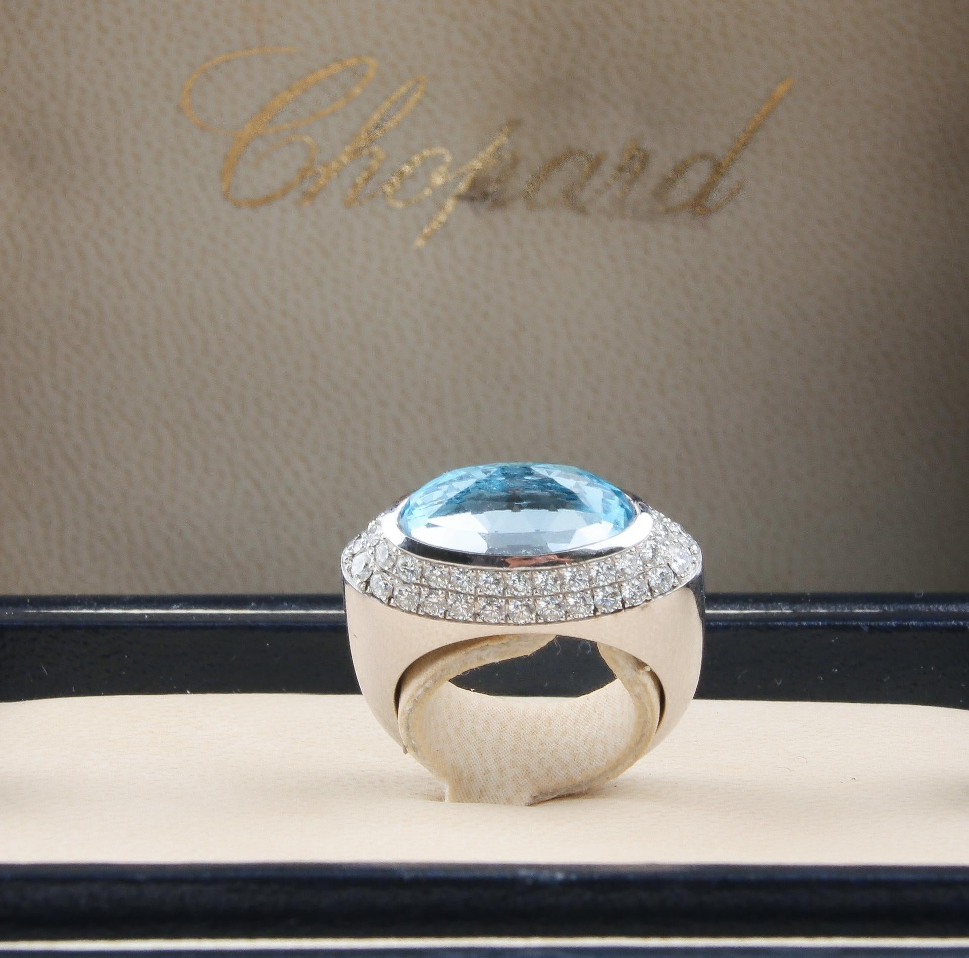 A truly magnificent white gold Chopard topaz and diamond ring. This stunning ring features a huge oval-shaped multi-faceted blue topaz, with brilliant-cut diamond surrounds. Signed and numbered Chopard 82/3839/7. Serial number 3084388. Topaz weight