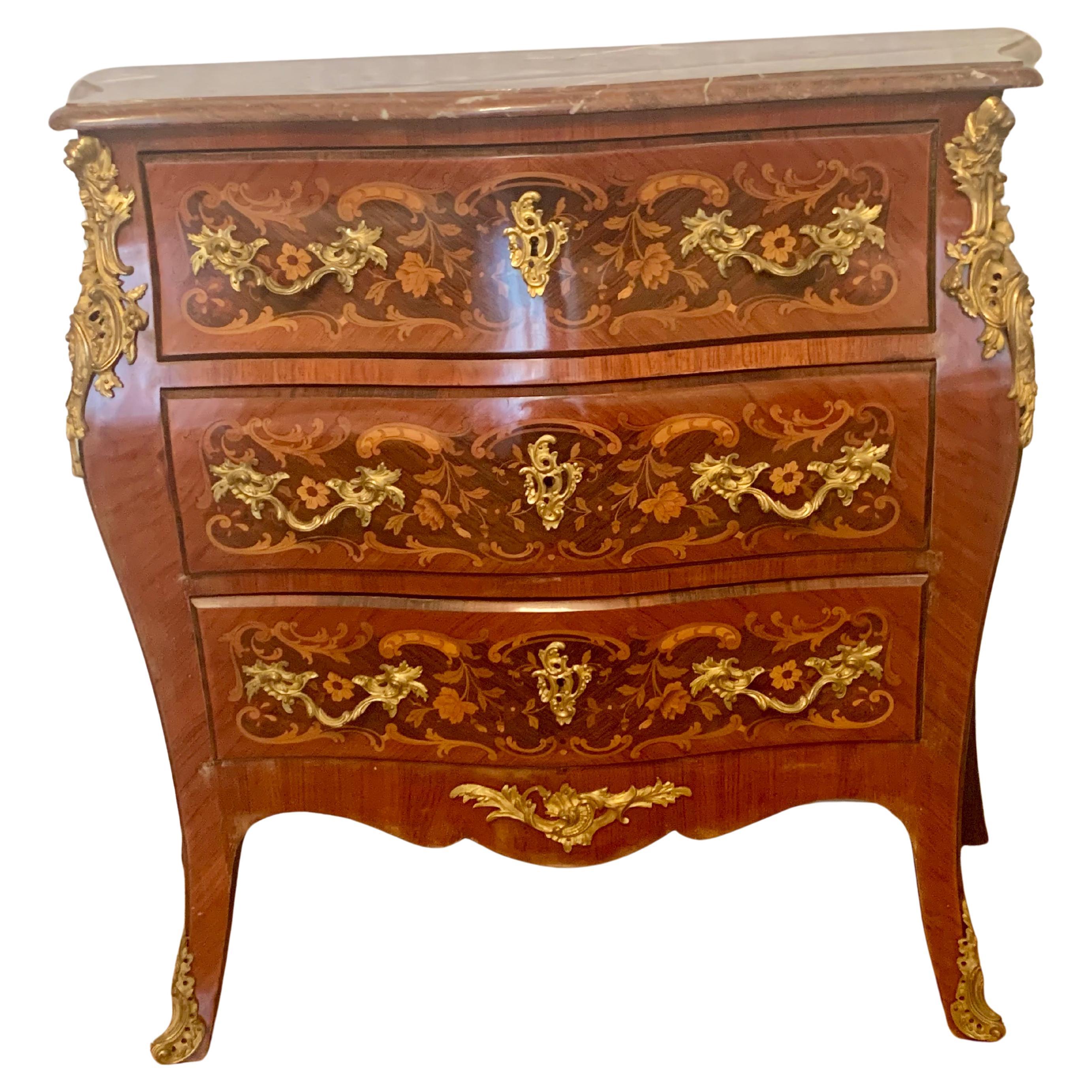 Bellissima cassettiera Napoleone !!! in intarsio e bronzo ormolato con piano in marmo. Ha tre cassetti sul davanti, le cadute di bronzo sul lato sono magnifiche, e termina con scarpe di bronzo incassate. Questo mobile è affascinante e carino,