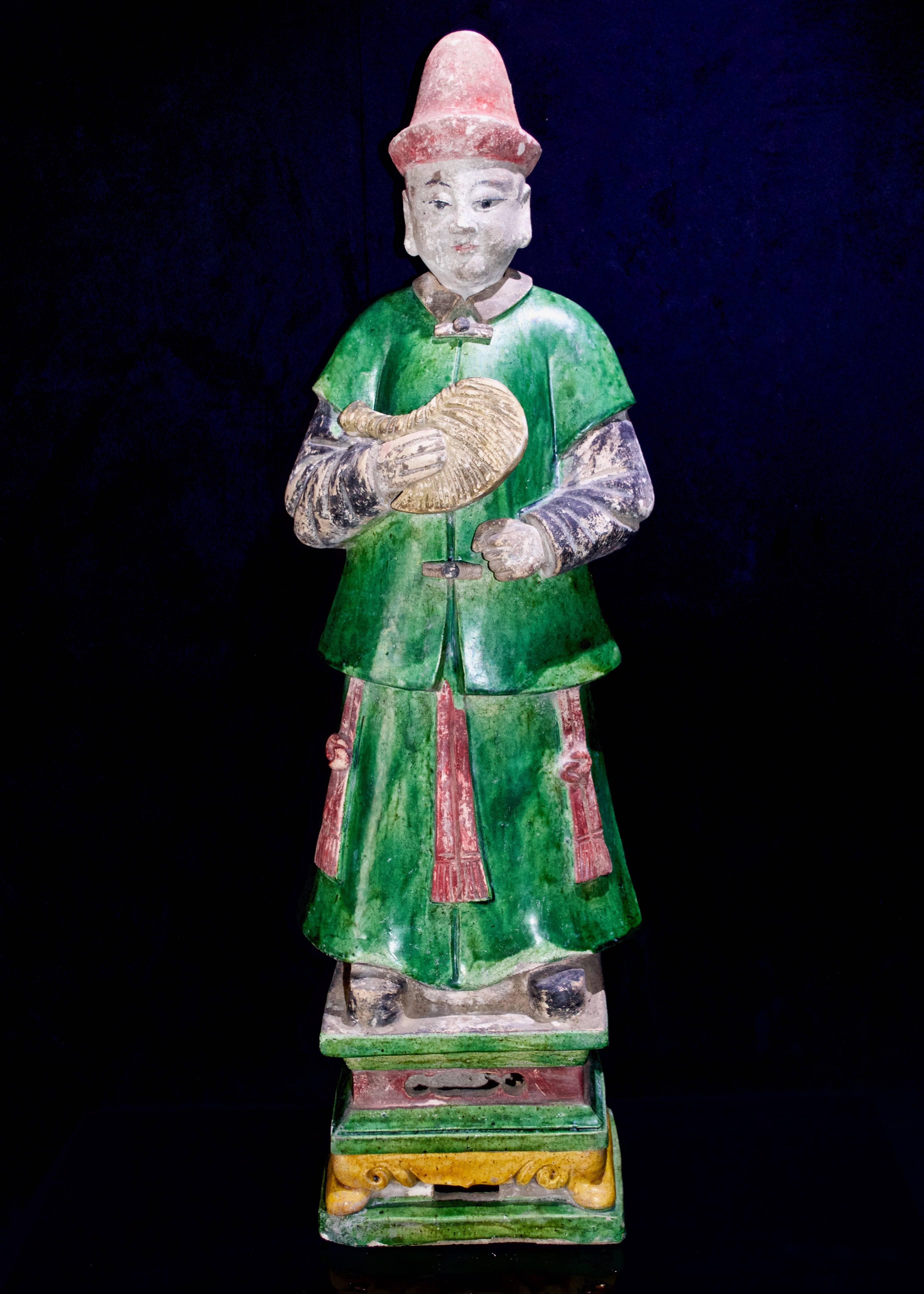 A magnificent pair of male and female courtiers from the Ming Dynasty (1368-1644 CE) in excellent condition. They are wearing traditional Daopao robes in green and black garments with red accents in an enamel finish. They are standing on a