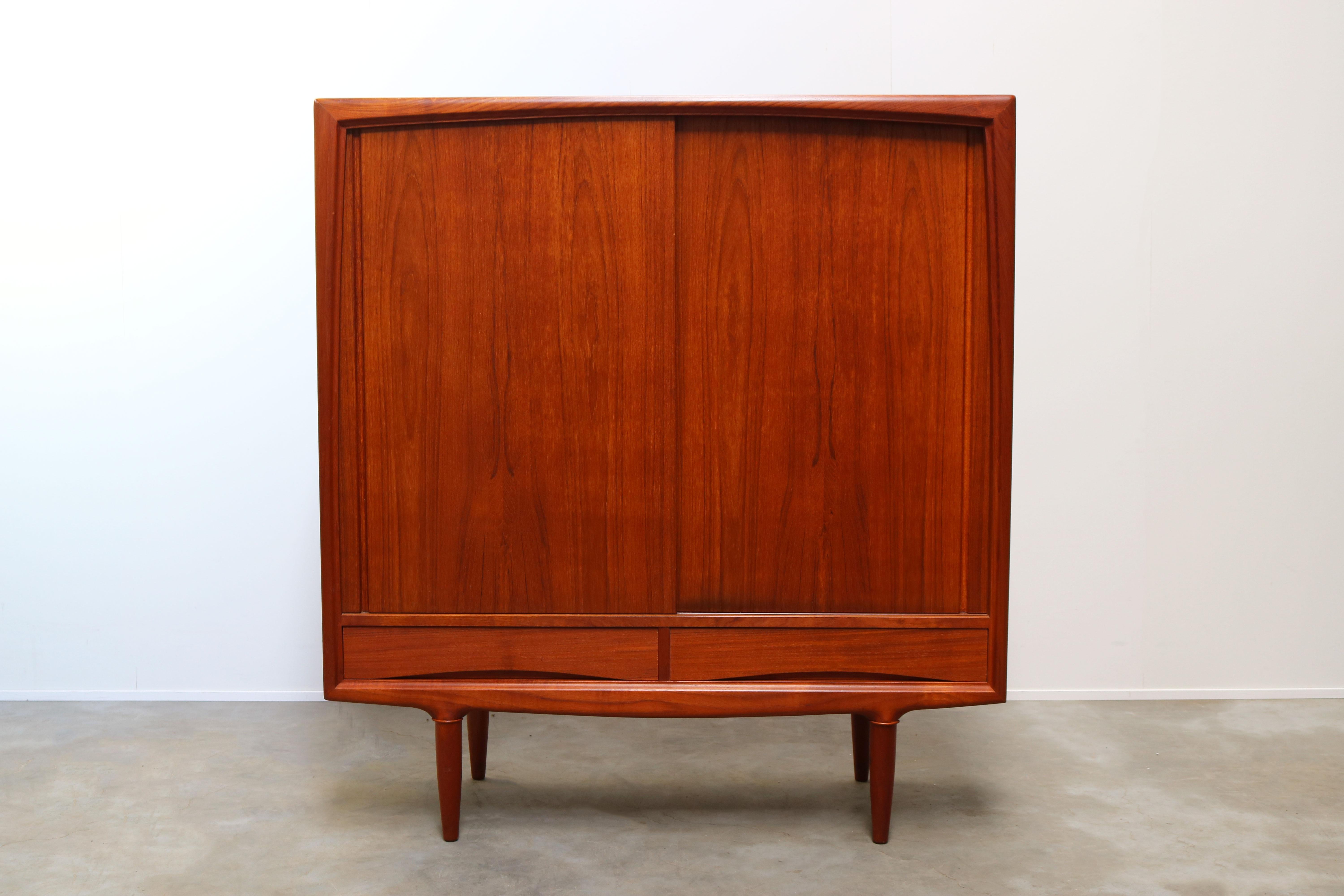 Magnificent Danish highboard / cabinet by danish designer Gunni Omann for Aco Mobler in the 1950s.
Wonderful organic design in teak. The cabinet has 2 sliding doors and 2 drawers. The interior has multiple adjustable shelves and 5 drawers providing