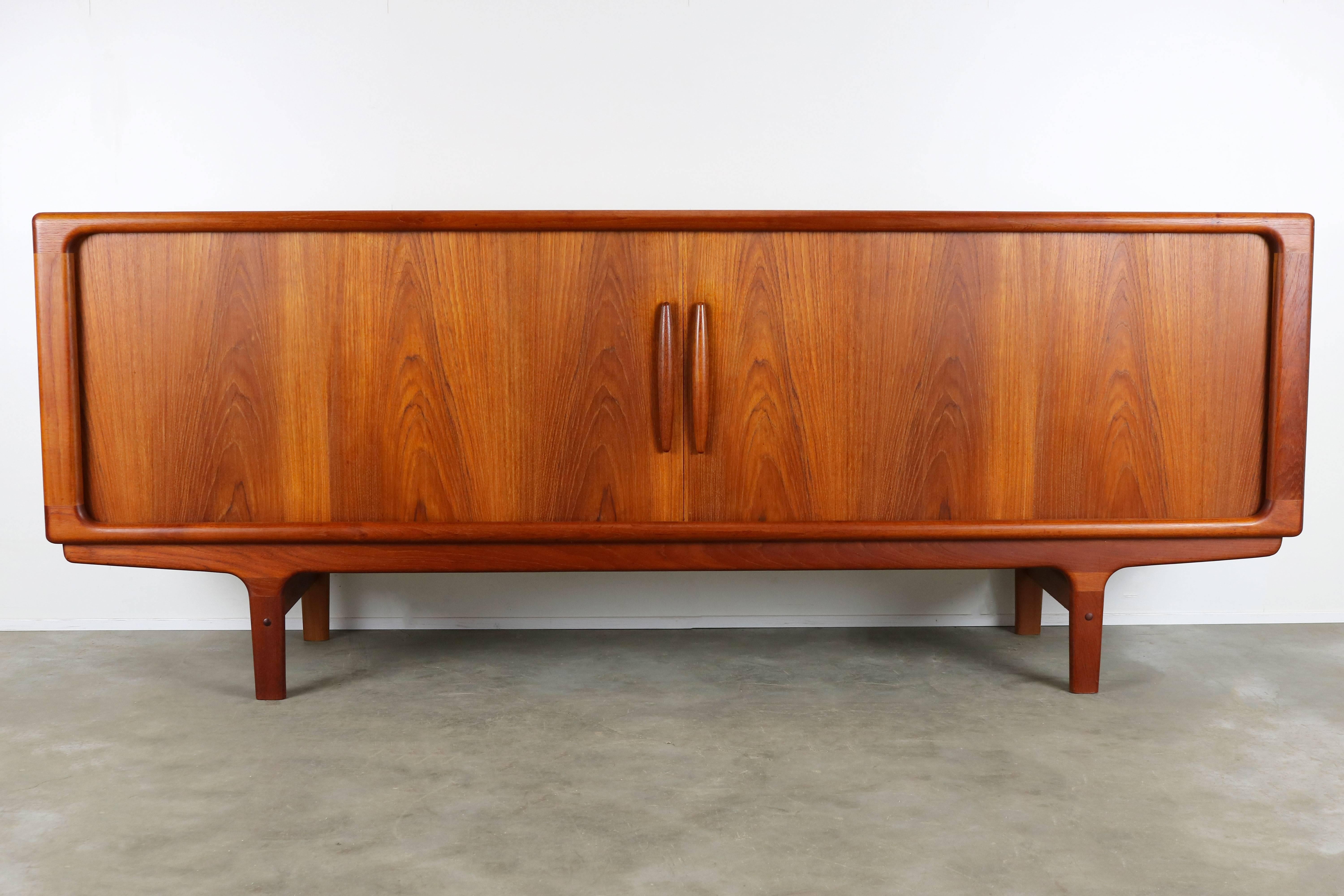 Magnificent Danish sculpted teak sideboard / credenza by Dyrland with tambour doors. Dyrlund is well known for their high quality midcentury furniture and this piece reflects that perfectly. The craftsmanship of this piece is of a very high level.