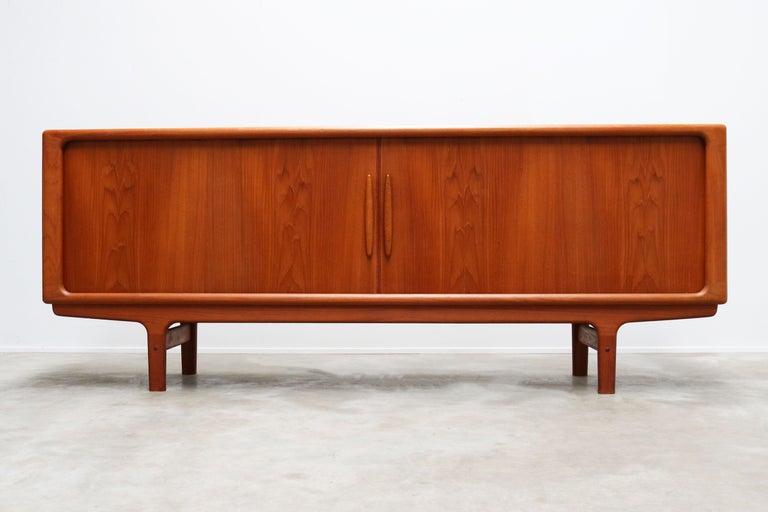 Magnificent Danish sculpted teak sideboard / credenza by Dyrland with tambour doors. Dyrlund is well known for their high quality midcentury furniture and this piece reflects that perfectly. The craftsmanship of this piece is of a very high level.