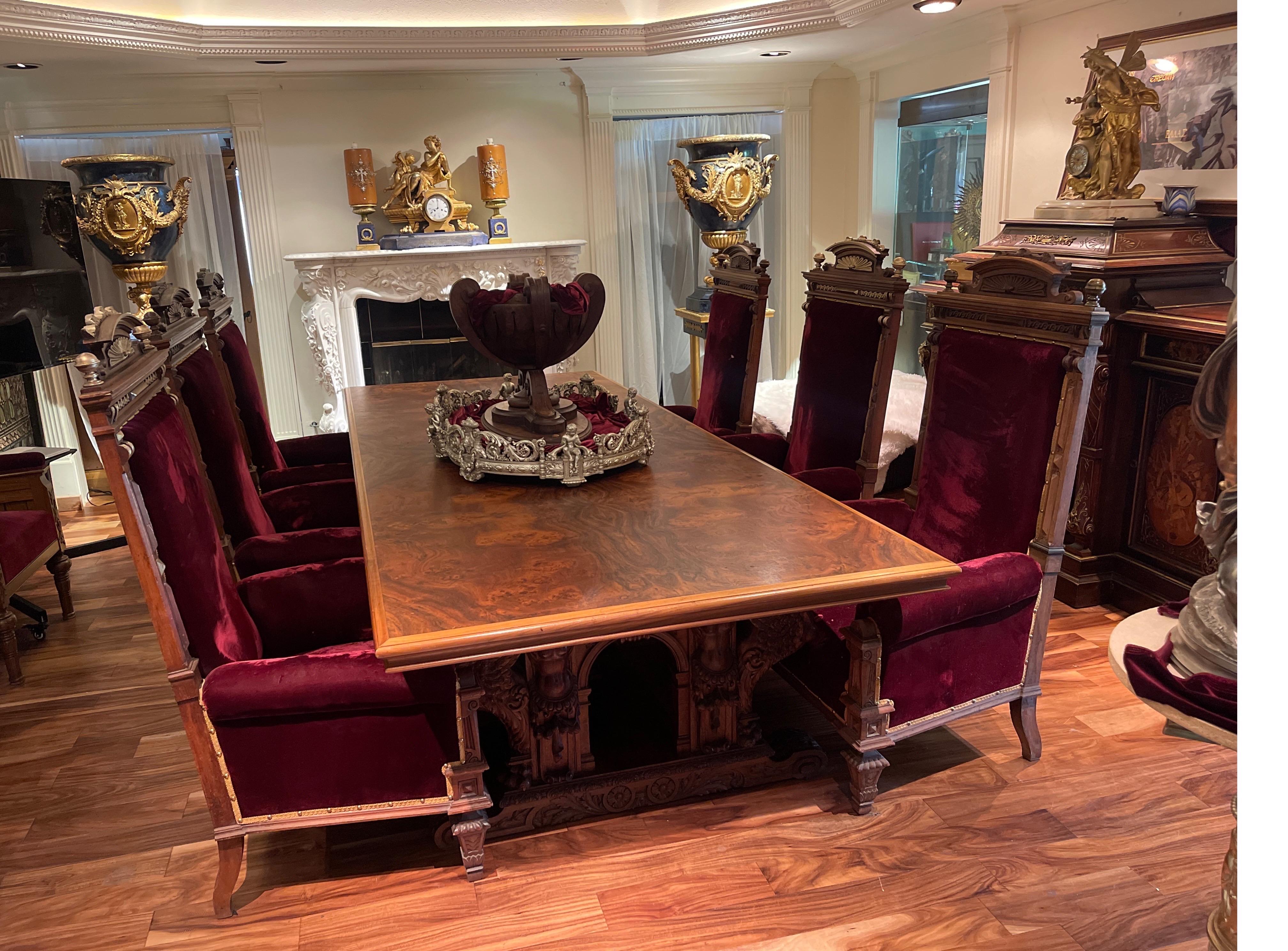 19th century Carved Burled Walnut Dinning Table with Red Velvet Arm Chairs.