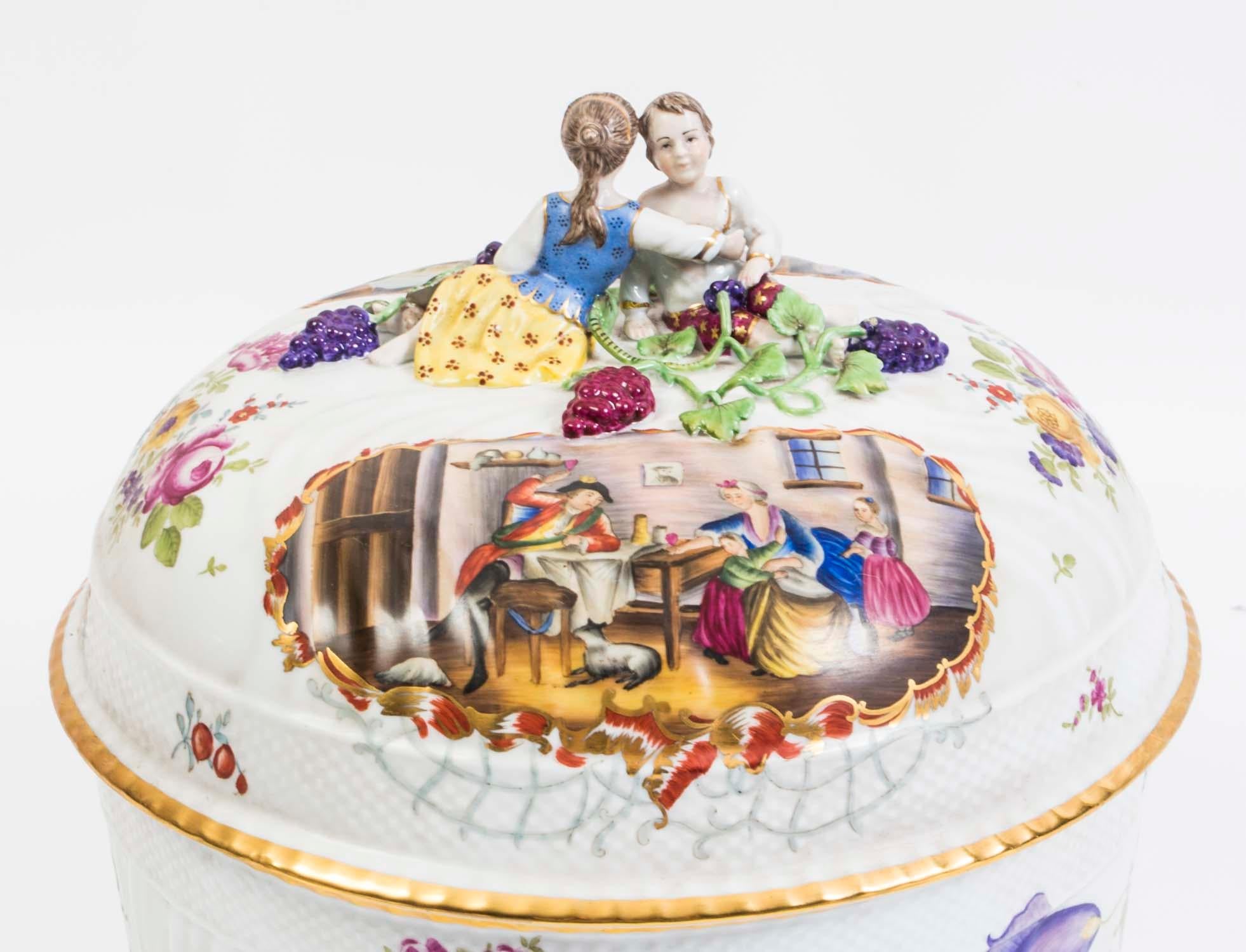 This is a delightful porcelain tureen with lid in Dresden style, dating from the last quarter of the 20th century.

Hand painted with classical scenes in an array of bright colors and beautiful figurines of a couple on the top.

This is a lovely