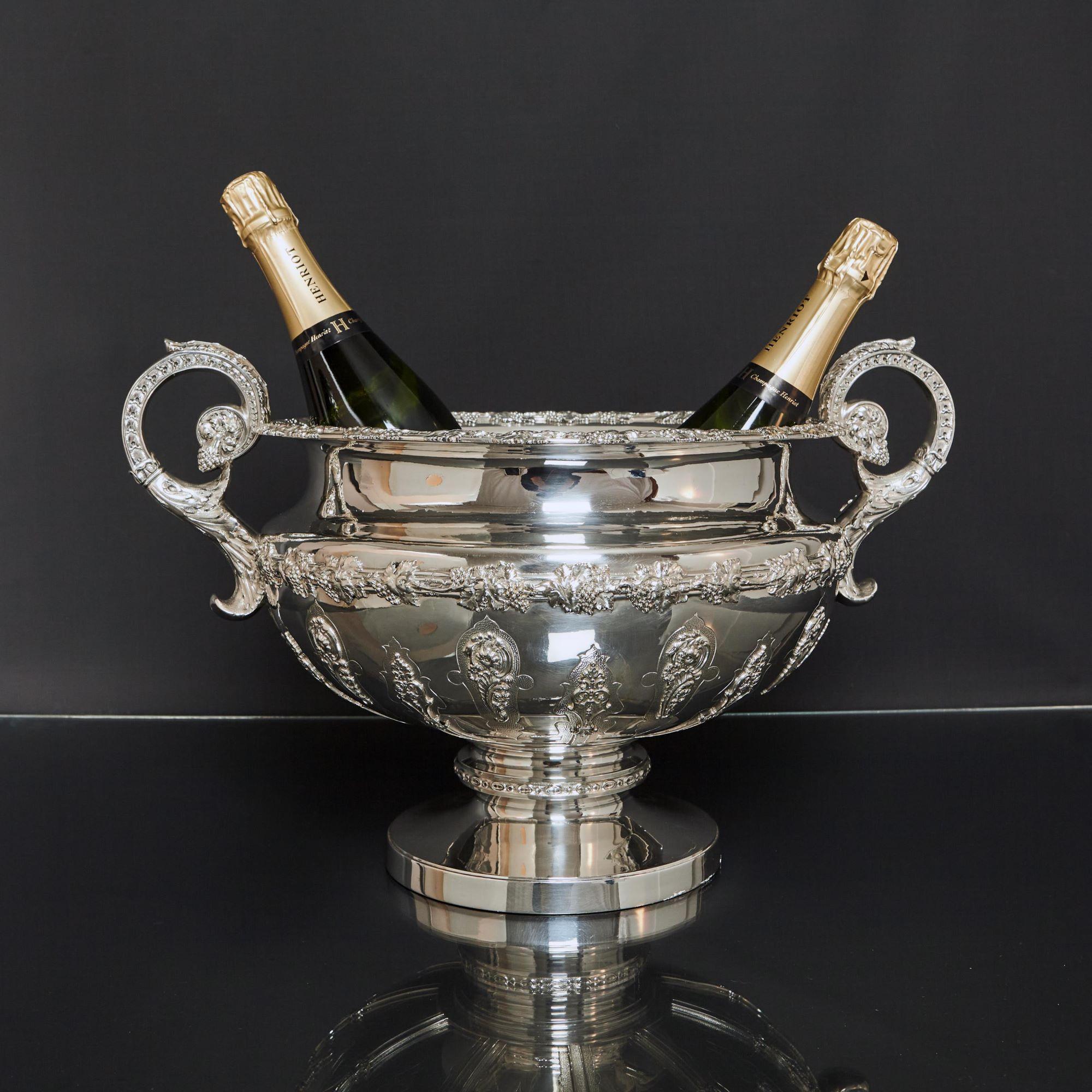 A large, impressive and fine quality silver wine cooler made at the turn of the 20th century by Mackay & Chisholm at 59 Princes Street, Edinburgh. The lower half of the body of this silver wine cooler is hand chased with Lamerie-style strapwork