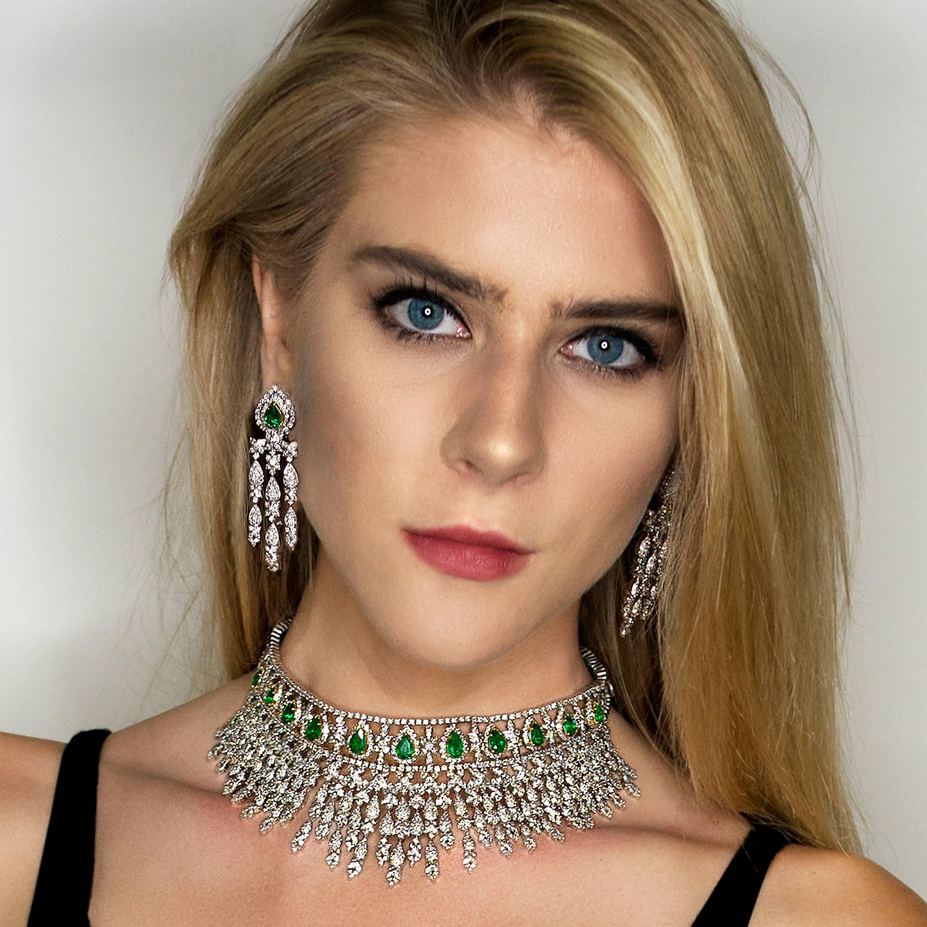 Fit for a queen! 18k White Gold Necklace & Earring Suite with 11 pear shape emeralds weighing 11.86 carats and approximately 33.00 carats of modern round brilliant diamonds. 