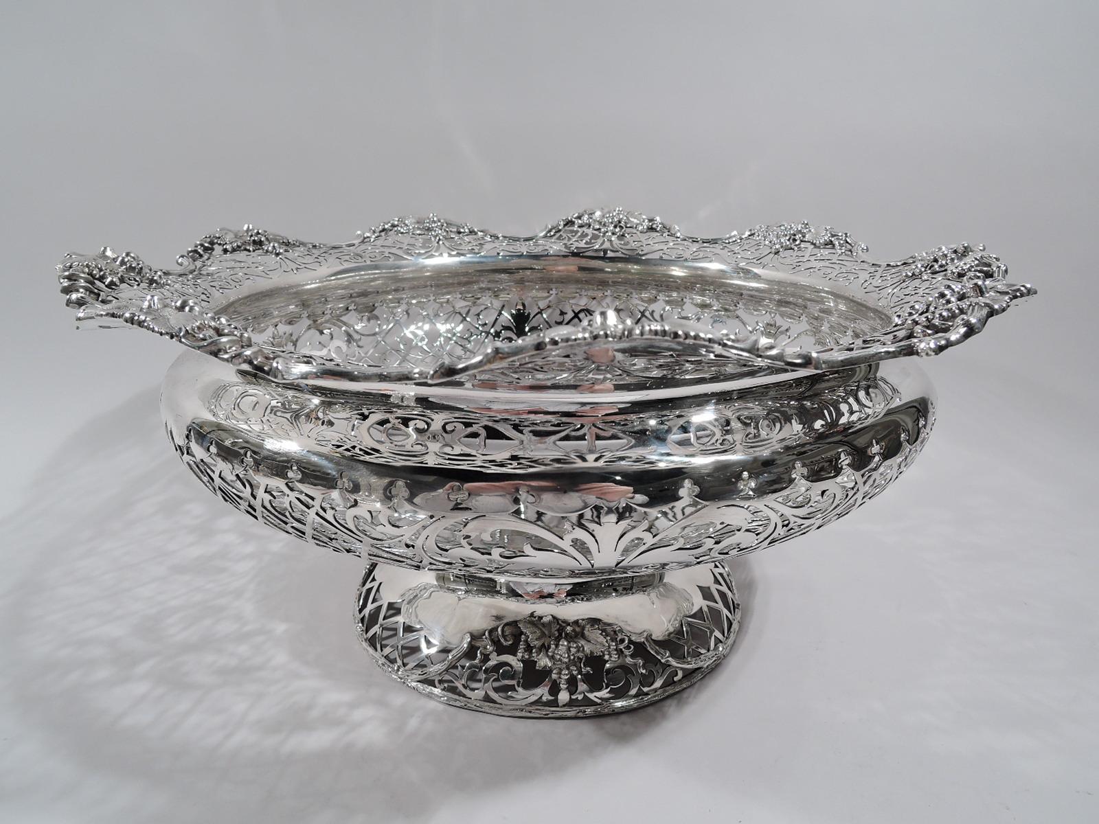 George V sterling silver centerpiece. Made by Mappin & Webb in Sheffield in 1913. Bellied bowl with solid multifoil well. Sides pierced trellis with entwined tendrils and solid leaf and scroll ornament. Shoulder and foot same with branch rim and