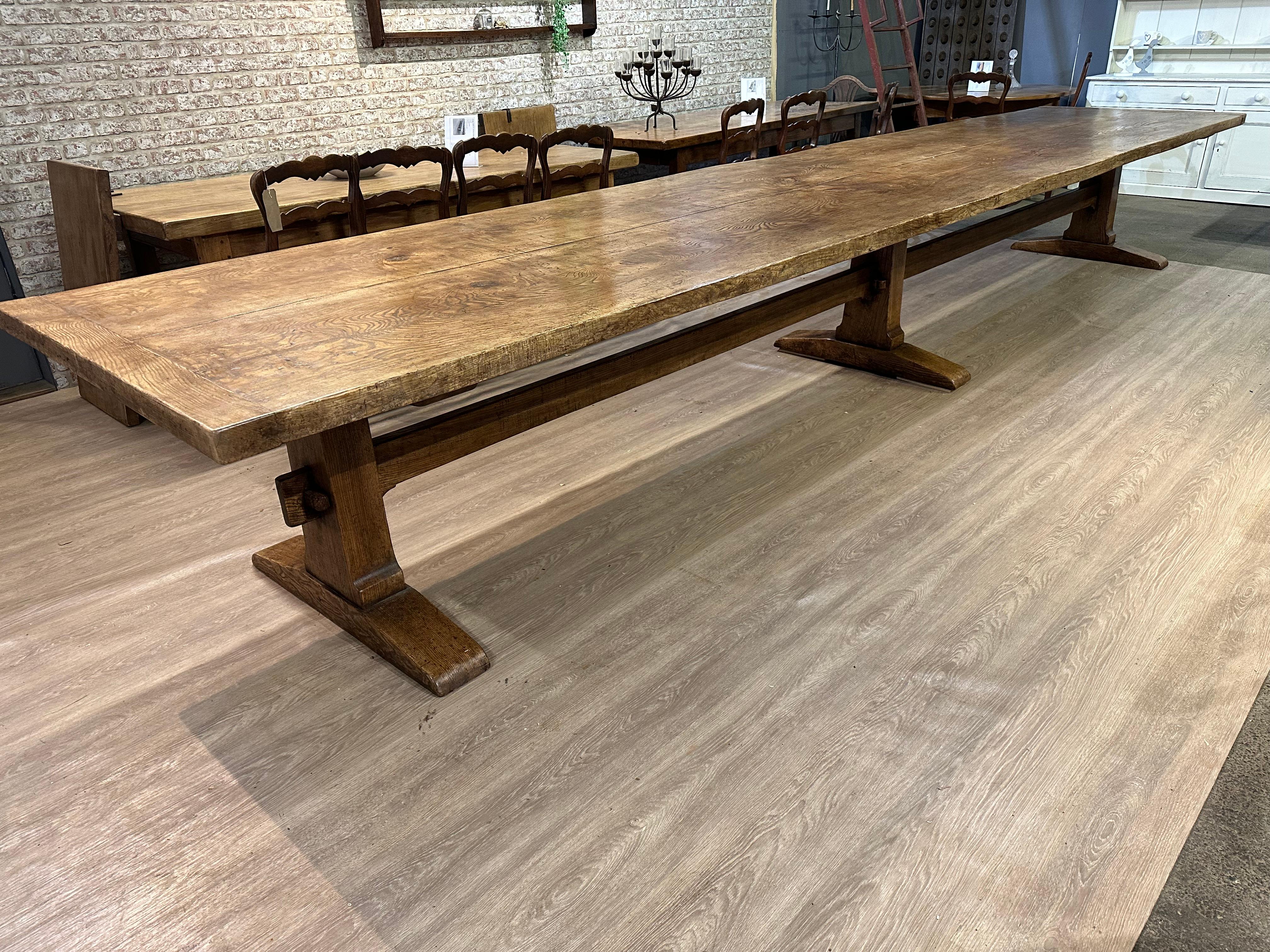 Magnificent figured ash two plank top refectory table. 17th-century style substantial three pillar table, constructed using a pair of booked matched planks, that have been pit sawn and hand-planed. The top is joined by cleated ends and five tenon