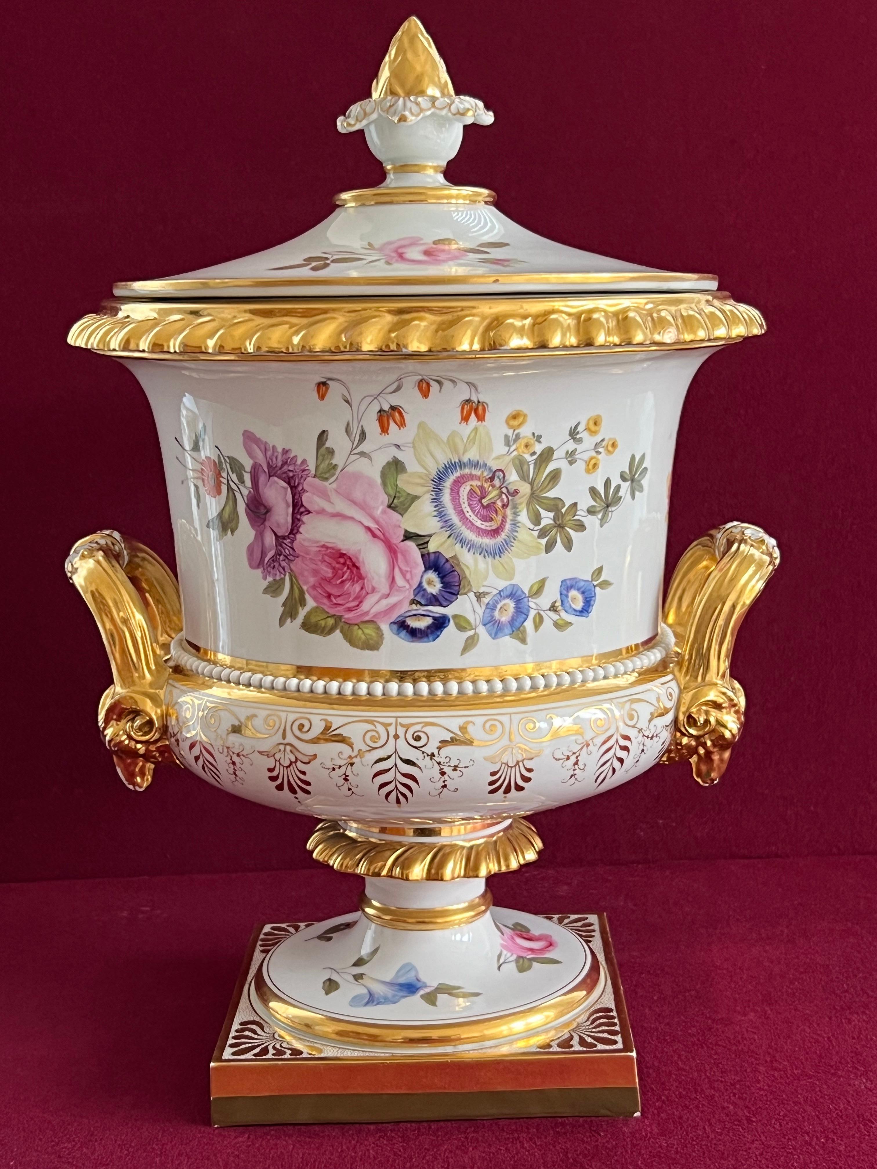 A magnificent Flight, Barr and Barr Worcester ice pail, liner and cover, circa 1820-30 Of campana shape on a square foot, the classical style handles with gilt rams' head terminals, painted with large sprays of colourful flowers and smaller sprigs