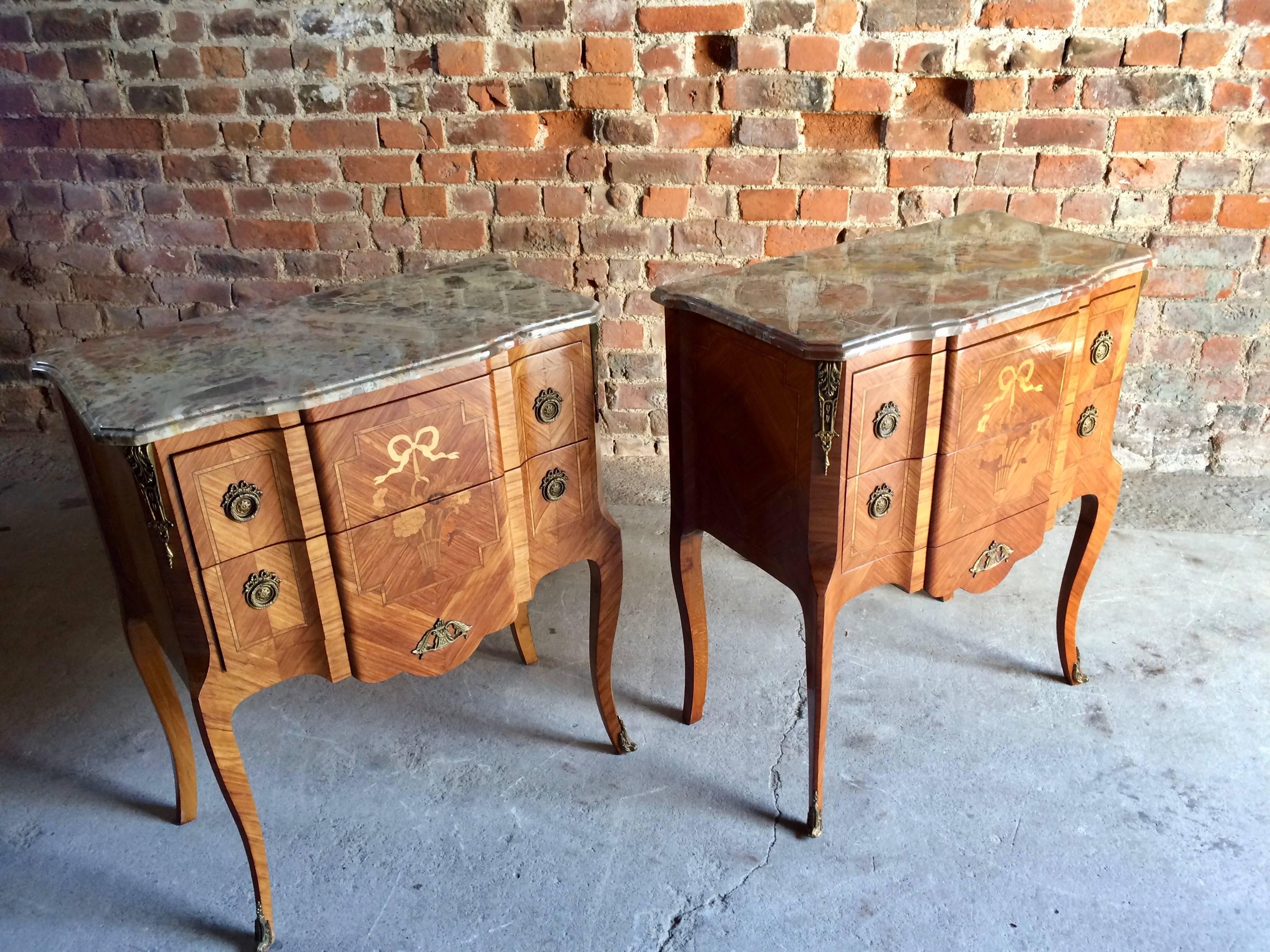 Magnificent pair of matching mid-20th century French Louis XV style kingswood marble topped bedside commodes circa 1950, the bevelled and contoured marble tops with the most wonderful colors over two shaped and scalloped drawers inlaid with