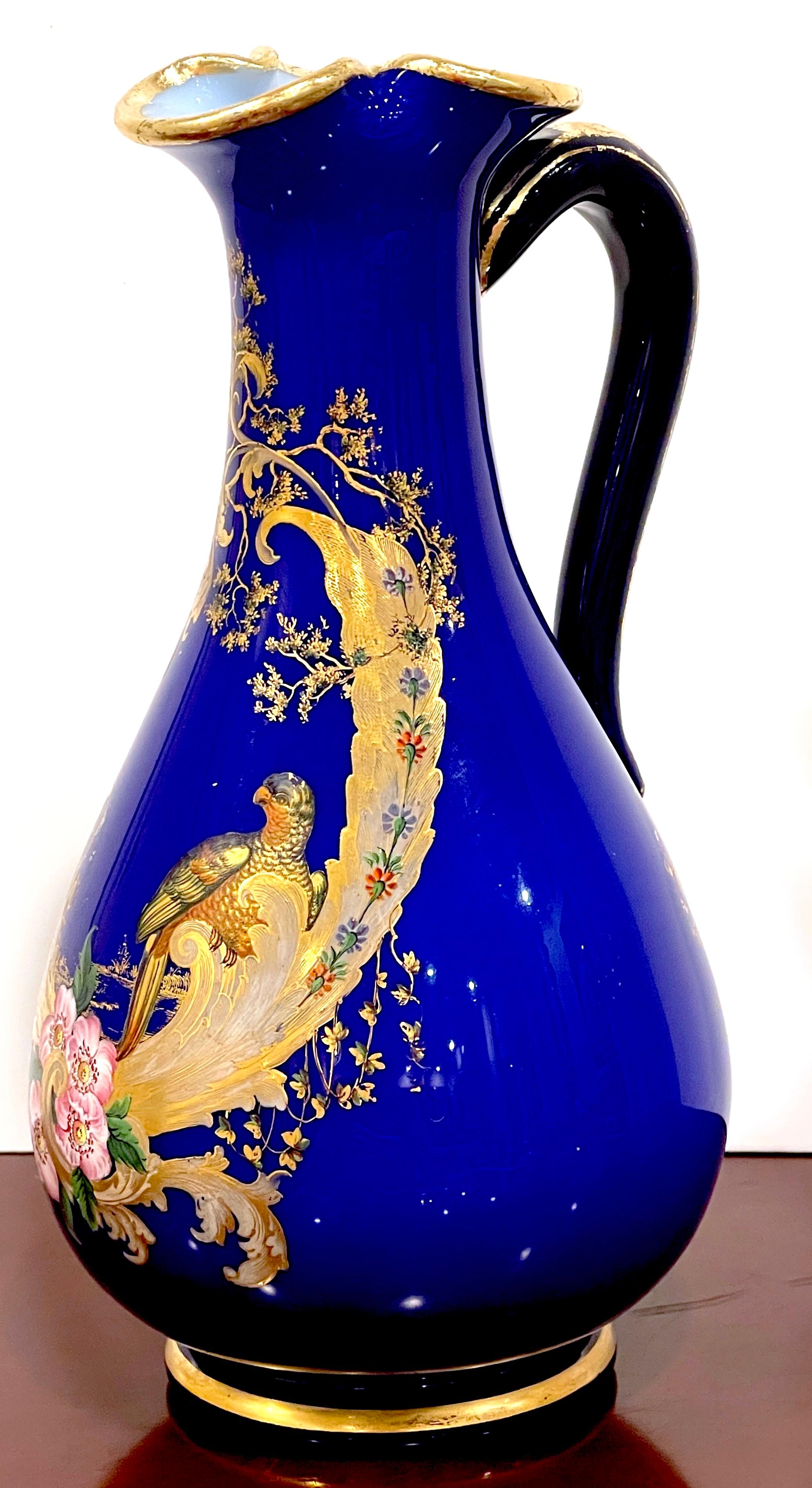 Magnificent French Cobalt Gilt Enameled Ewer, Bird of Paradise in Landscape 
Paris, France, 1870s

This French cobalt gilt enameled ewer from the 1870s is truly magnificent in its design and craftsmanship. Standing at a height of 10 inches, it