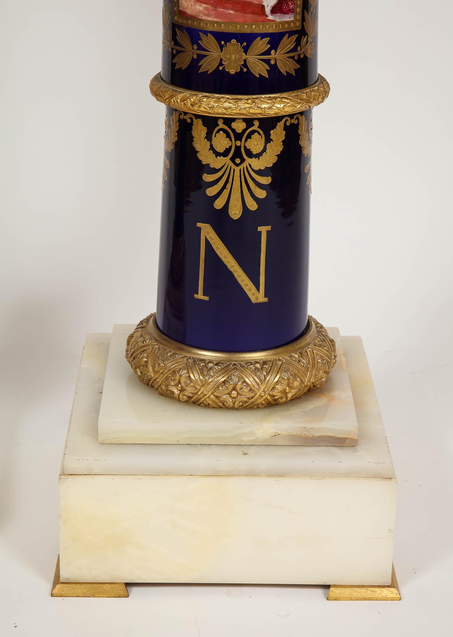 An exceptionally large and magnificent pair of French Empire Napoleonic Sèvres porcelain gilt bronze mounted pedestals. These are a exceptionally beautiful pair of 19th century 24-karat raised gold decorated, gilt bronze-mounted, onyx and Sèvres