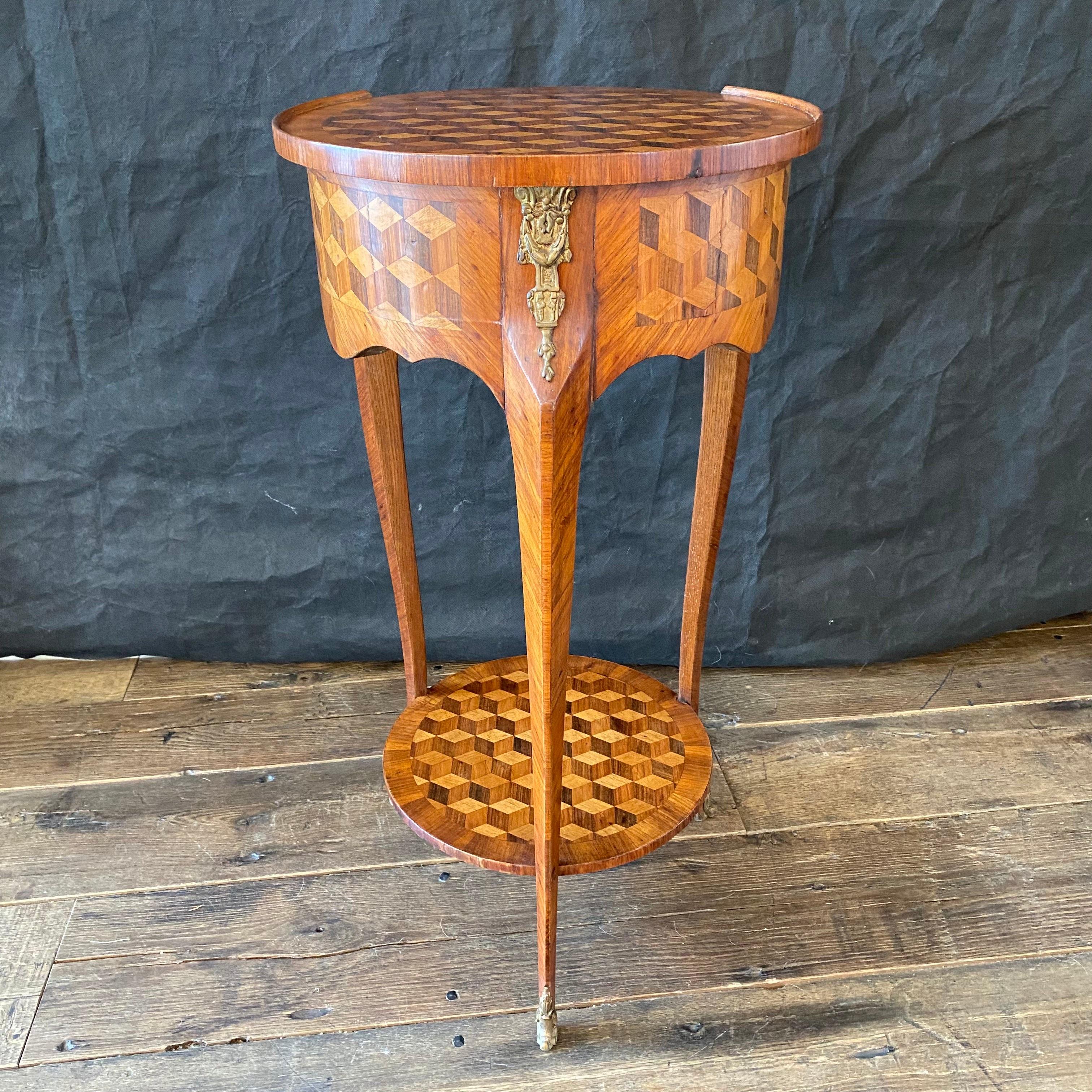 A gorgeous French Louis XVI bronze mounted parquetry side table. Each piece of this side table is beautifully hand-cut and fitted with a beautiful geometric diamond parquetry design of prismatic pieces of light and dark hardwood. The top sides of