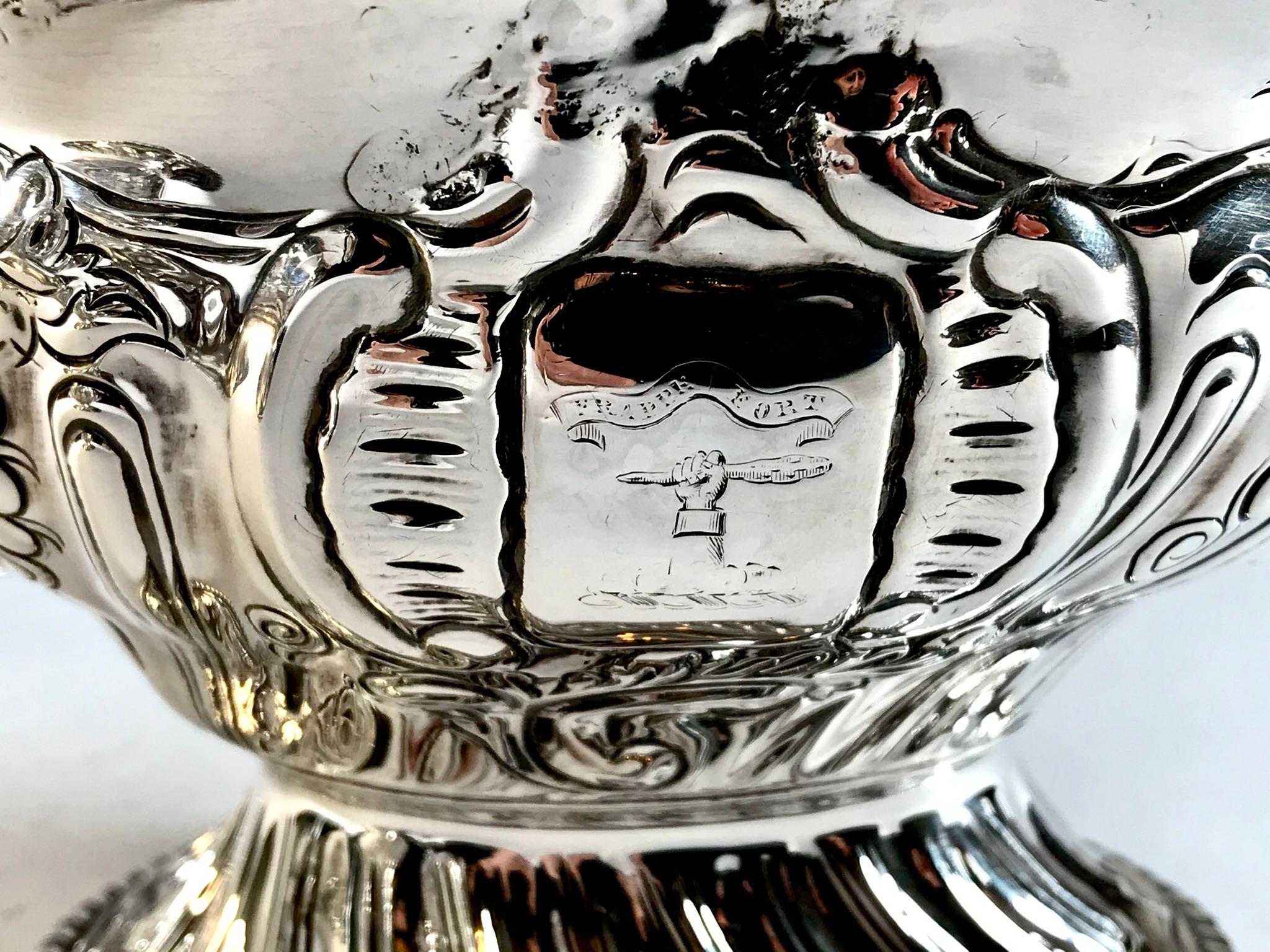 A magnificent Centre piece comprising of 3 solid silver bowls richly decorated with grape vines and grapes.
there is a cartouche to the front of all 3 pieces with an Armorial Crest 