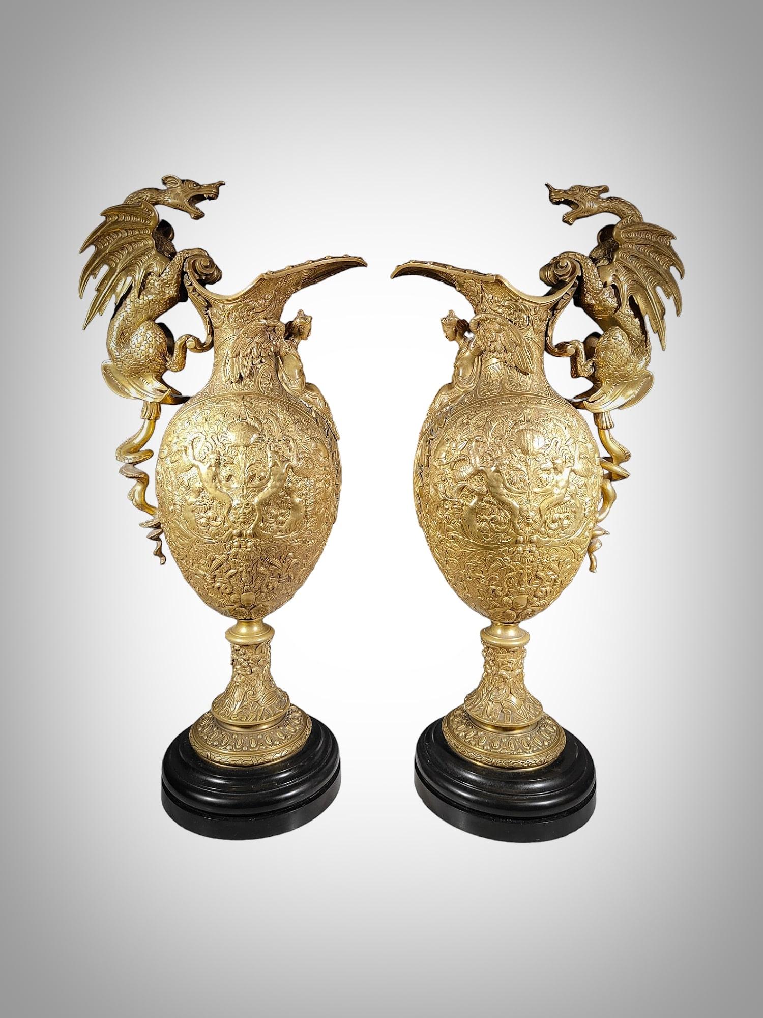 Enhance your living space with this exquisite pair of grand bronze vases, showcasing the impeccable craftsmanship of the 19th century. These impressive vases feature intricate relief chiseling with Renaissance motifs, and their dragon-shaped handles