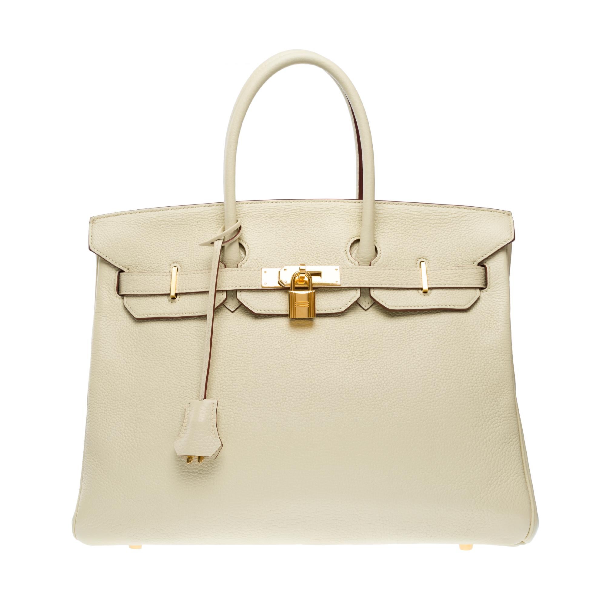 Splendid​ ​&​ ​Rare​ ​Handbag​ ​Birkin​ ​35​ ​in​ ​Vanille​ ​calf​ ​Togo​ ​leather​ ​,​ ​gold​ ​plated​ ​metal​ ​trim​ ​,double​ ​handle​ ​in​ ​beige​ ​leather​ ​for​ ​hand​ ​carry

Flap​ ​closure
Inner​ ​lining​ ​in​ ​beige​ ​leather​ ​,​ ​a​
