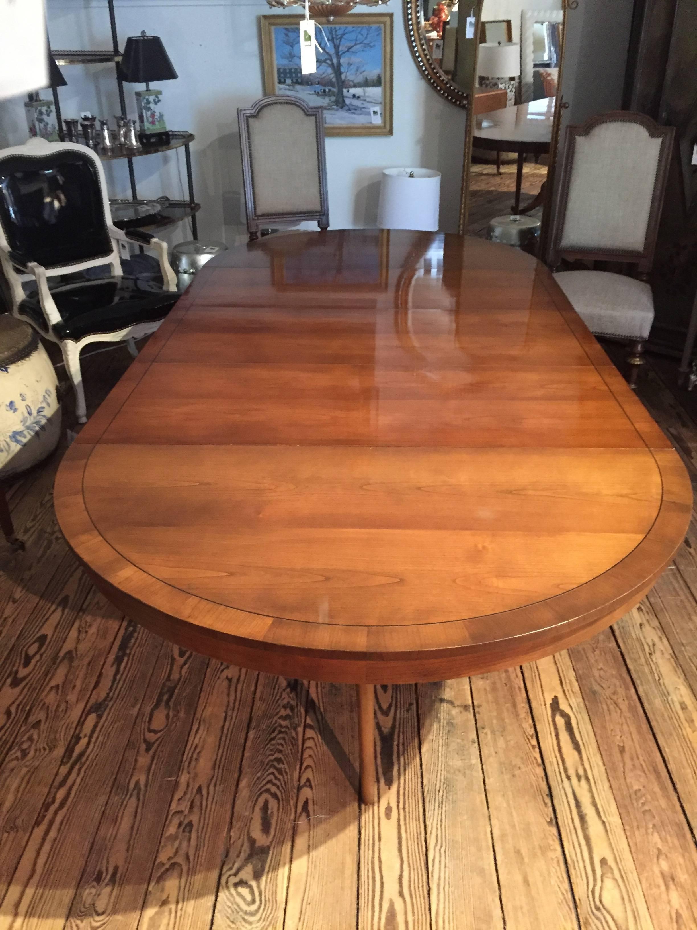 Fabulously expandable or shrinkable dining table, 4 ft round at its smallest, and then ingeniously pulls apart to make room for three leaves to create an elegant very long oval. Each leaf is 18 inches. Has just been restored so in beautiful vintage
