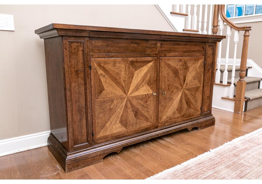 A Large and impressive Cabinet with Elemental form and Subtle Color. Large and very well made Renaissance style sideboard with two drawers over two cabinet doors. The doors with Star form Marquetry panels in decorative contrasting wood  resting on a